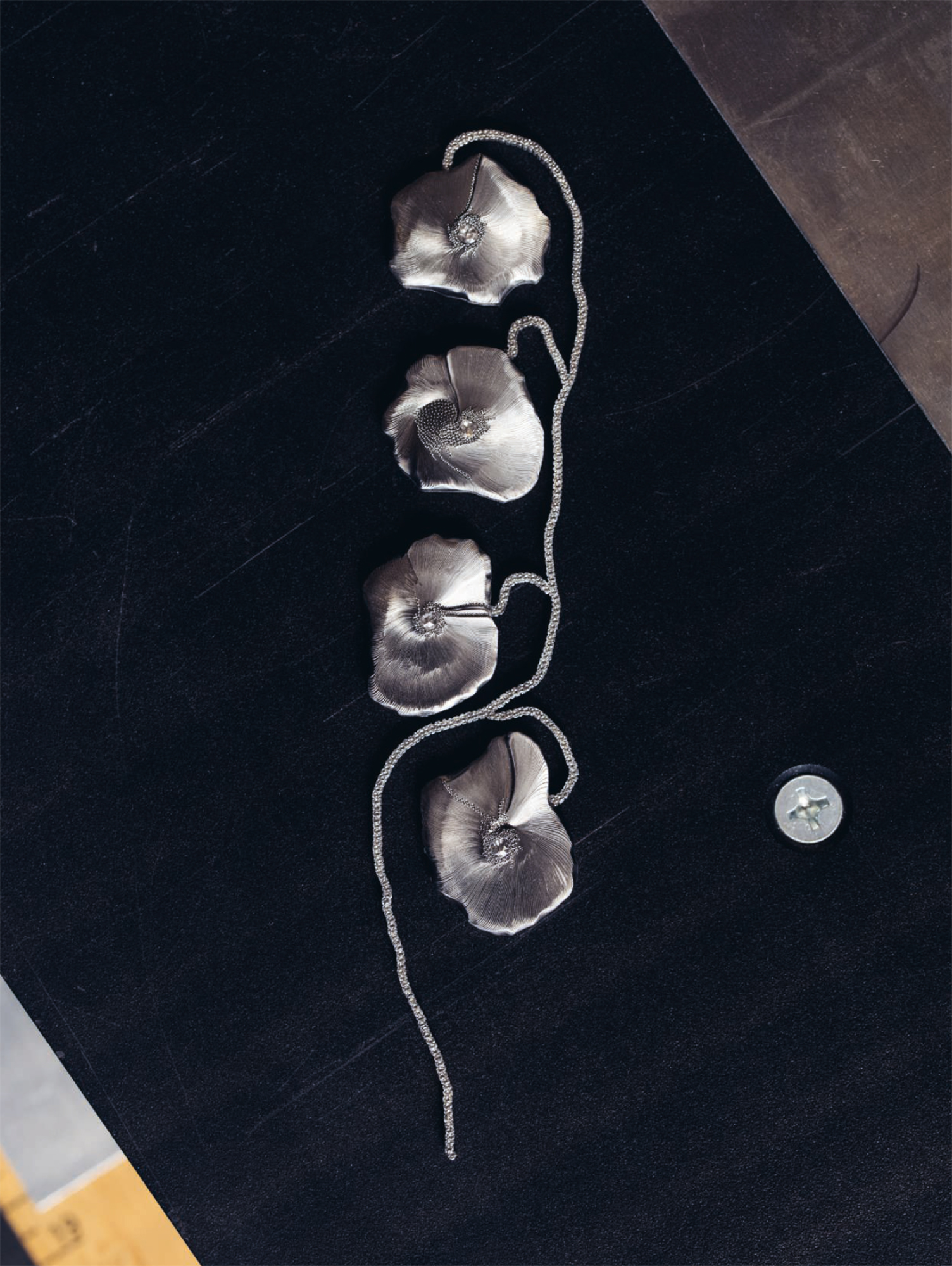 Poppies, 2010. Hand-carved stainless-steel brooch set with diamonds. Photo: Geordie Wood