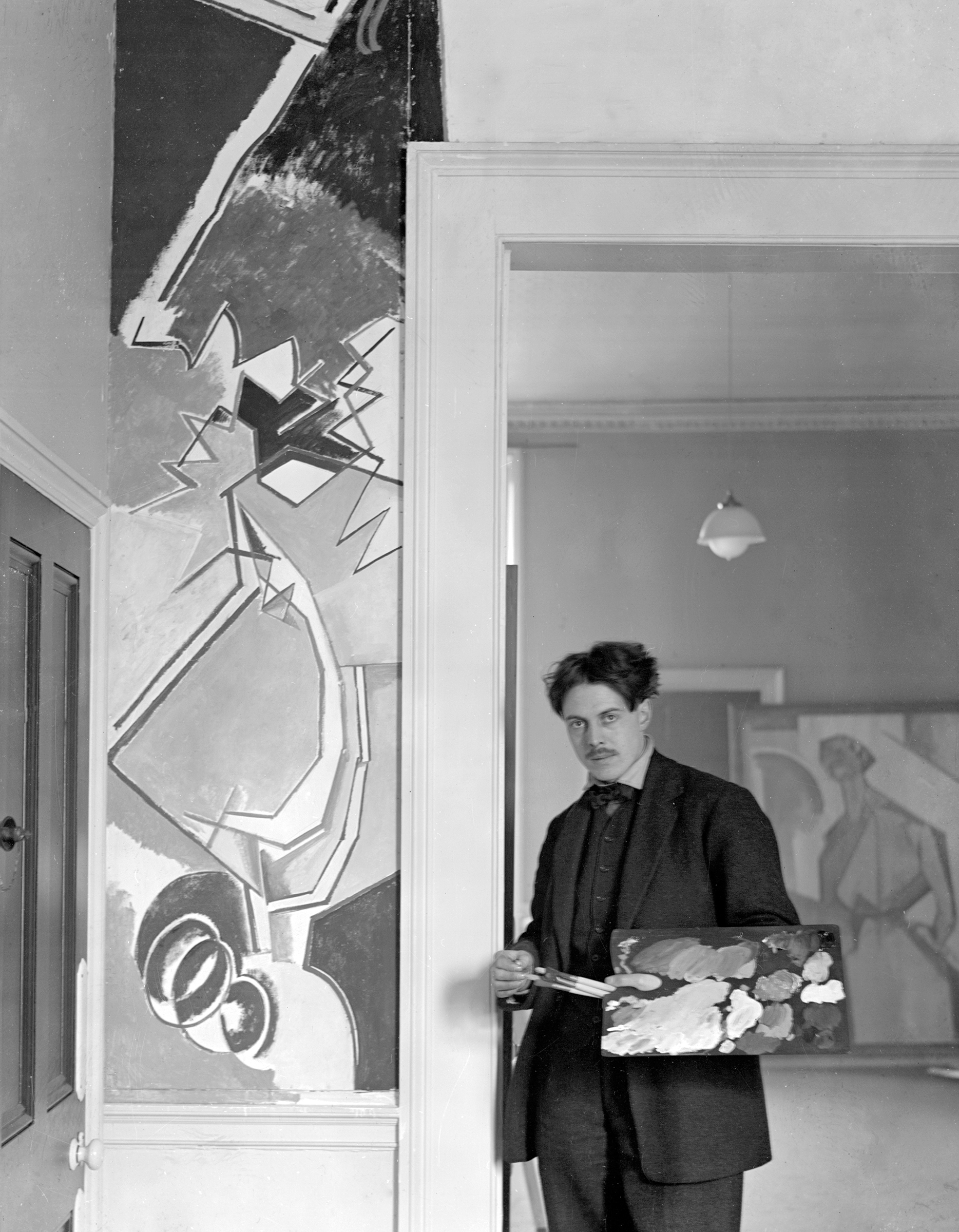Wyndham Lewis at the Rebel Art Centre, the Vorticists’ headquarters on Great Ormond Street, London. Photo: TopFoto. Artwork: © Wyndham Lewis Memorial Trust. All rights reserved 2023 / Bridgeman Images