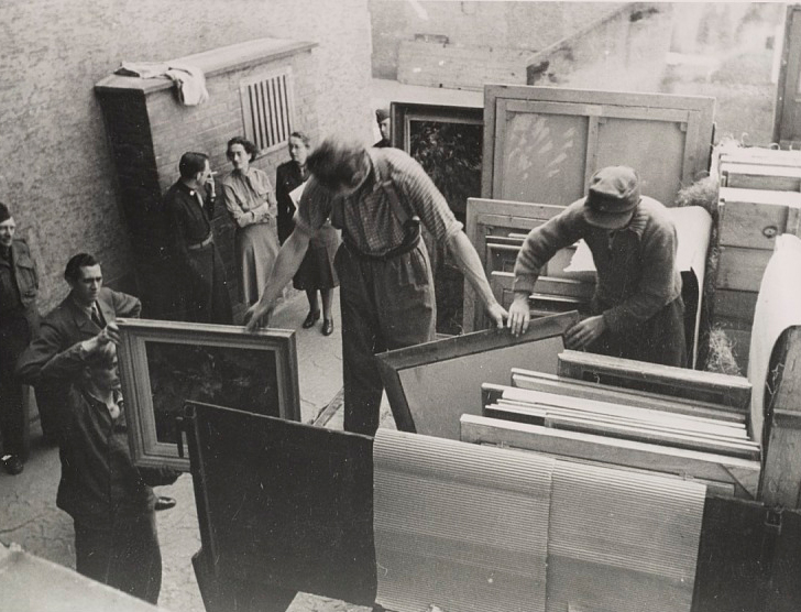 Edith Standen, Rose Valland and a soldier converse while men prepare paintings for transportation, 1946. James J. Rorimer papers, 1921-1982. Archives of American Art, Smithsonian Institution