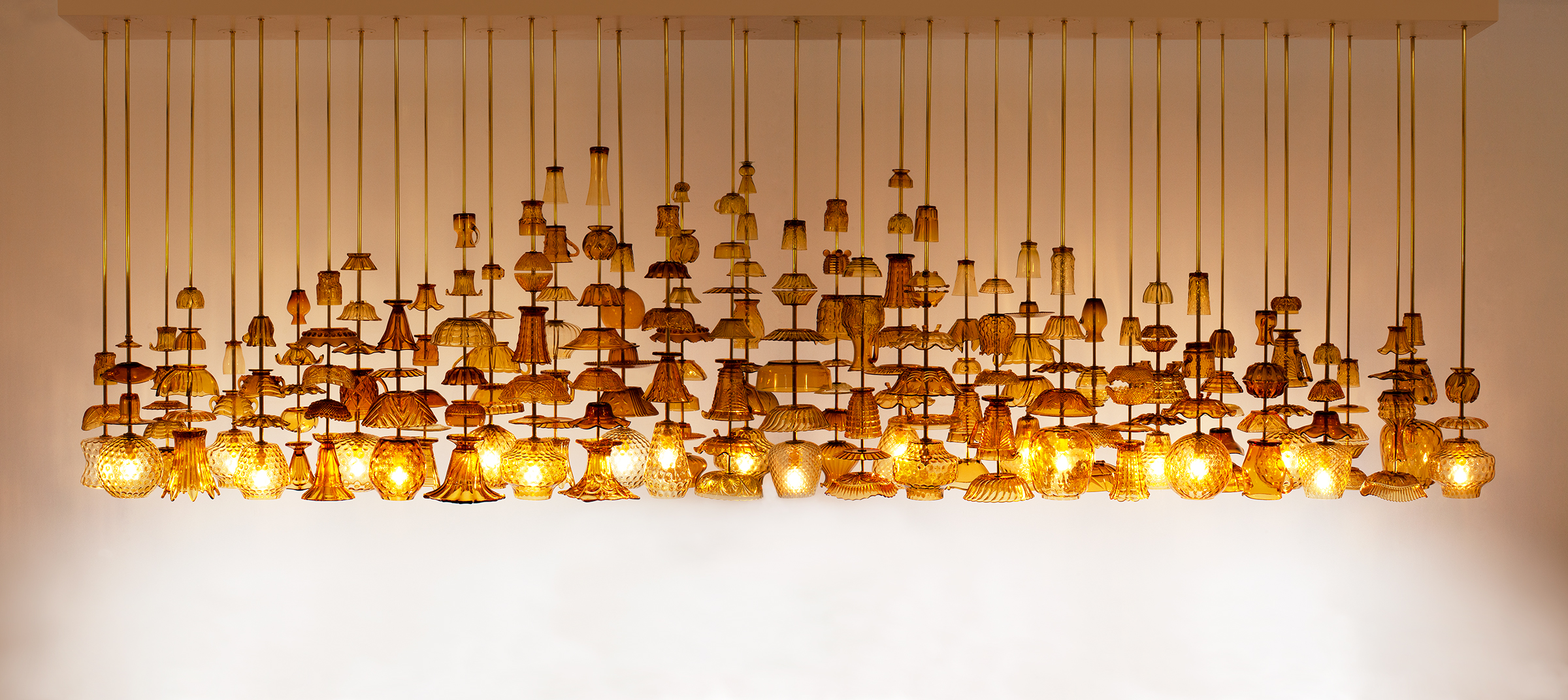 Stuart Haygarth, Flame 2013, 2013. Vintage amber glassware, brass rods, powder coated aluminium