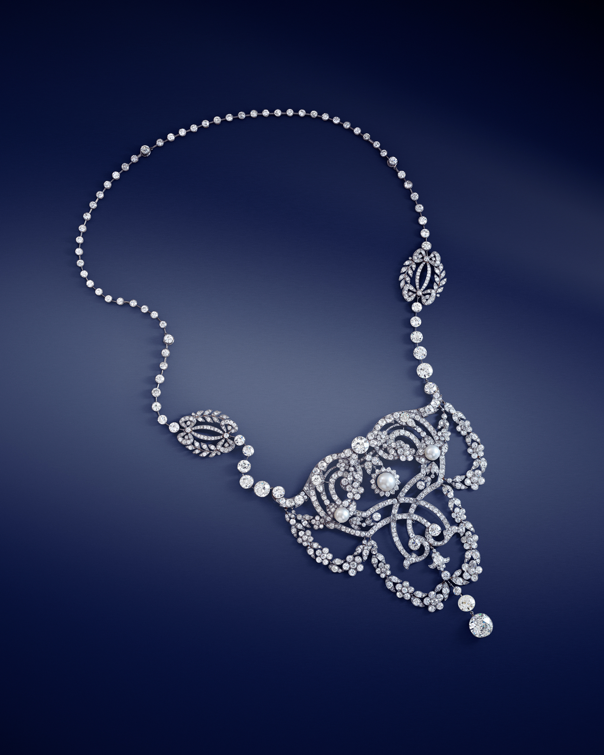 A Cartier Belle Epoque natural pearl and diamond &lsquo;garland style&rsquo; devant-de-corsage, circa 1902