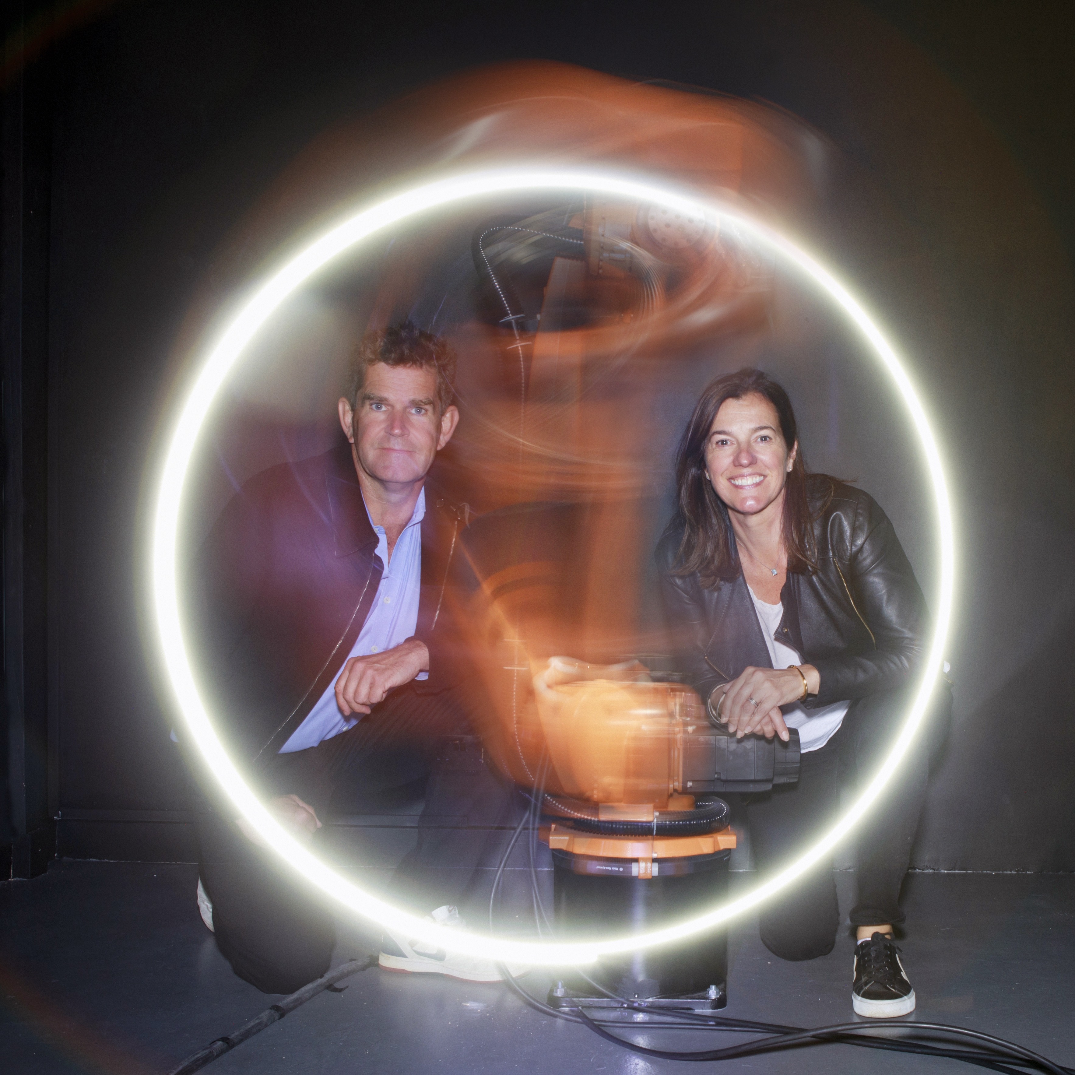 Rob and Nick Carter with Heidi, the car-making robot that has turned its ‘gripper’ to art. Photo: James Kelly