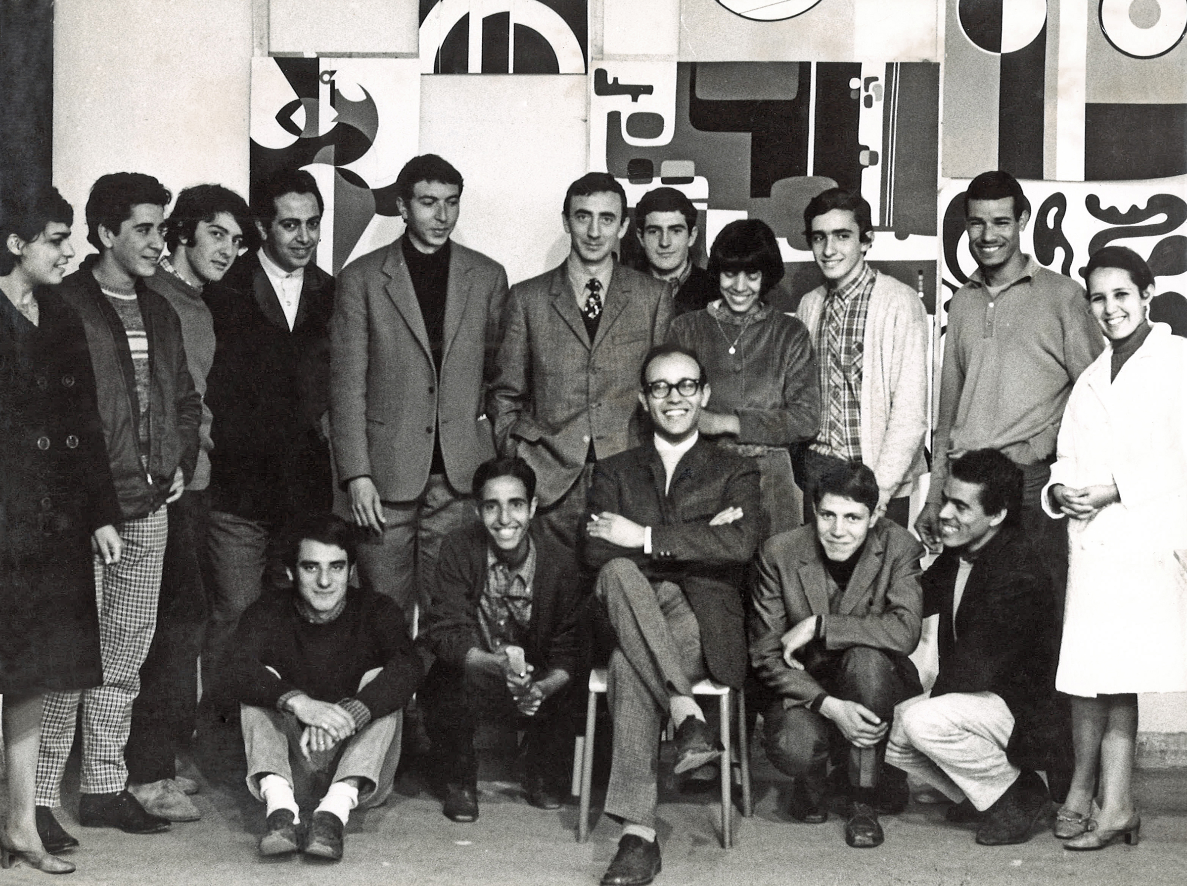 Mohamed Melehi (in chair) at the Casablanca Art School with a group of teachers (including Mohammed Chabaa and Farid Belkahia) and students (among them, on the far right, Malika Agueznay)
