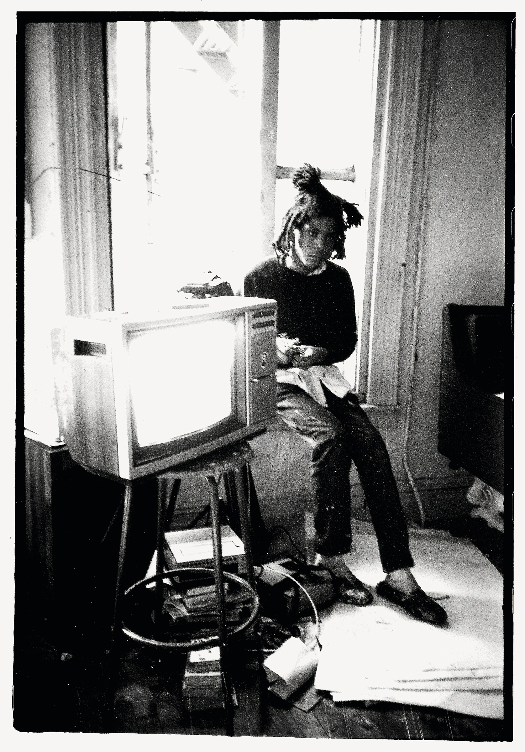 Jean-Michel Basquiat in his studio, New York, 1983. Photo: © Roland Hagenberg