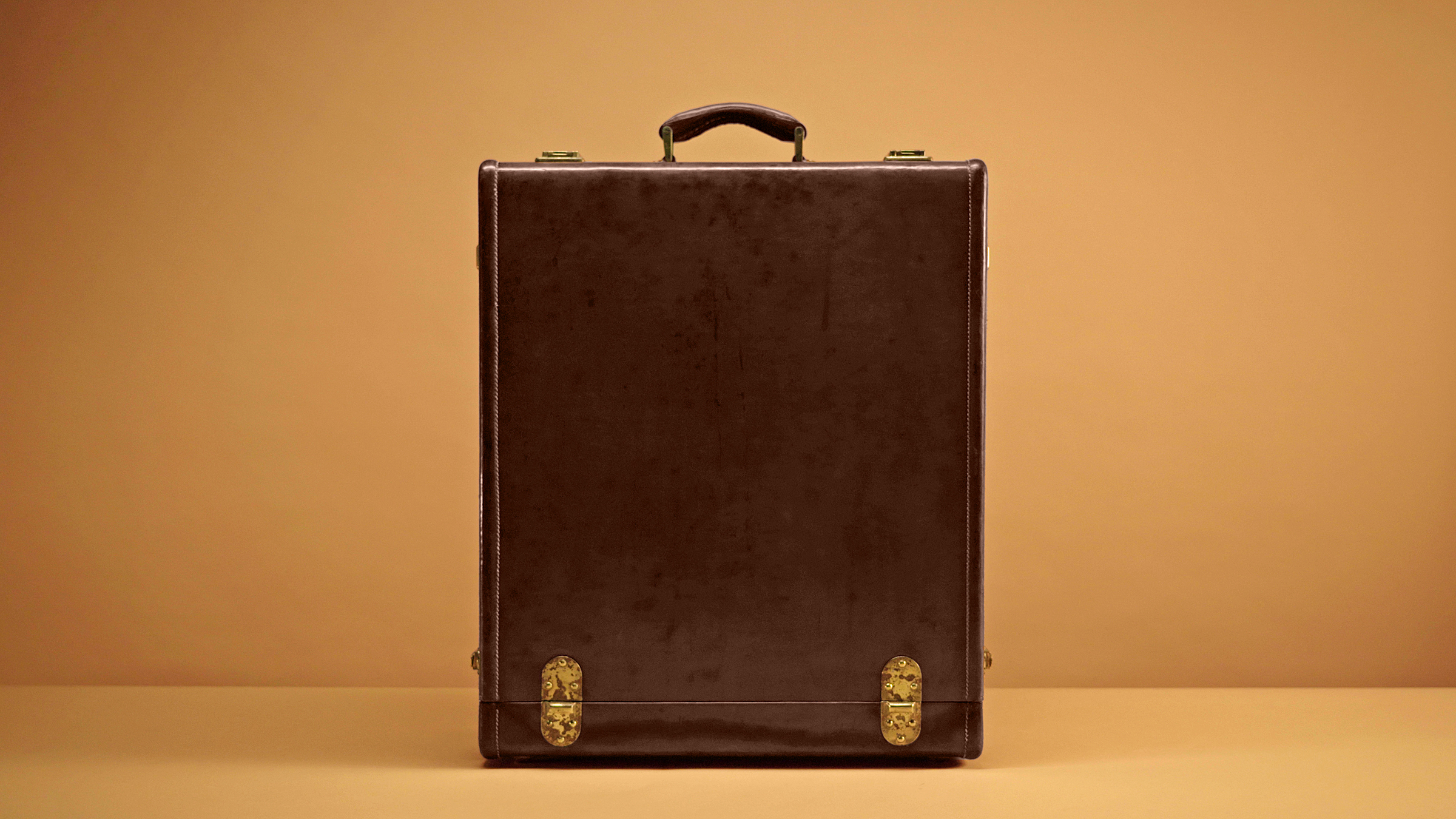 A 1930s leather suitcase from the Gucci Archive at Palazzo Settimanni in Florence, with a powder-pink silk moiré lining featuring the ‘Liftboy’ insignia — a proud reference to Guccio Gucci’s time working at The Savoy. Photo: Courtesy of Gucci Vault