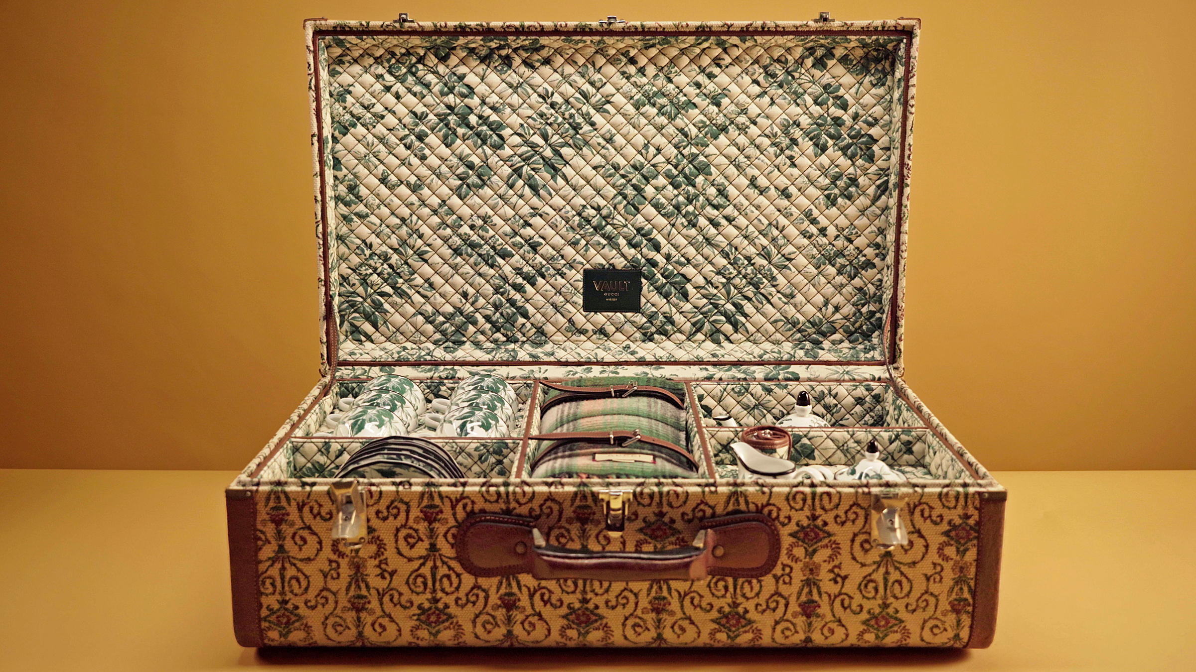 Inside the 1950s ‘Rinascimento’ suitcase from Gucci Vault, which has been refashioned by artisans into a picnic set featuring cups, saucers and a teapot. Photo: Courtesy of Gucci Vault