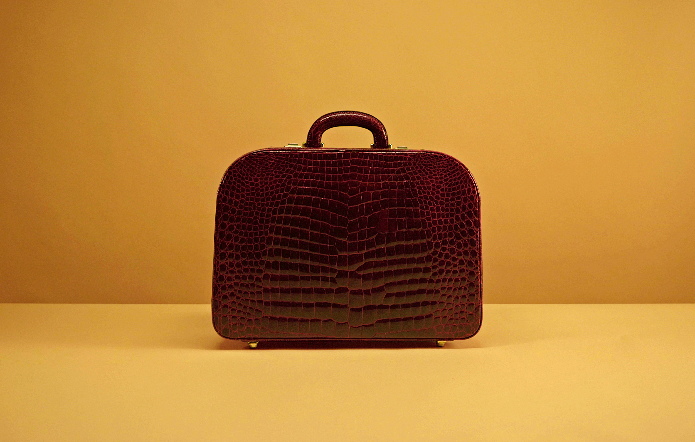 A 1960s burgundy ‘Bombe effect’ crocodile suitcase from the Gucci Archive, with a gold closure typical of Gucci pieces from the period. Photo: Courtesy of Gucci Vault