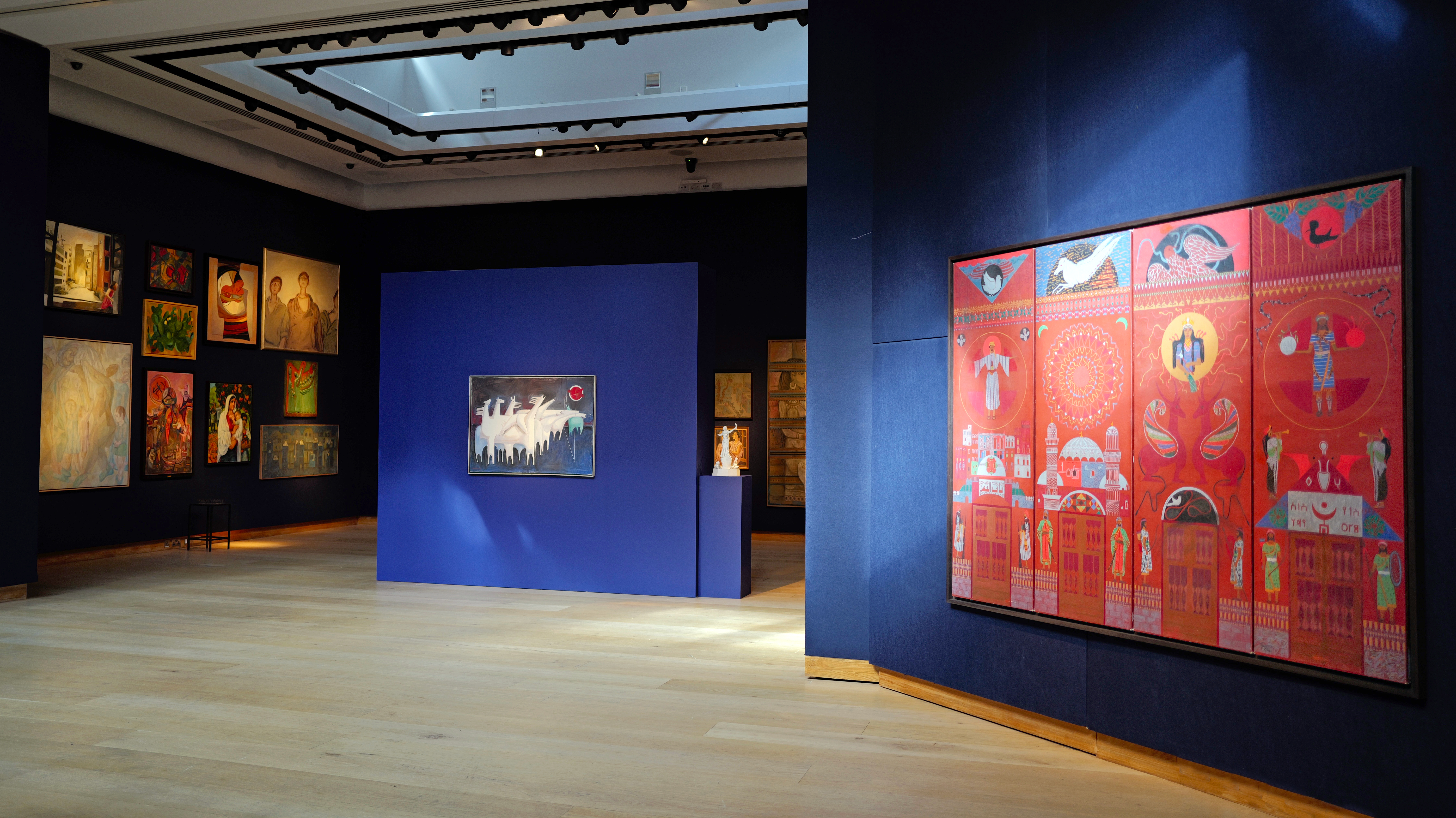Installation view of Kawkaba: Highlights from the Barjeel Art Foundation. Centre, Kadhim Hayder (Iraq, 1932-1985), Fatigued Ten Horses Converse with Nothing, 1965. Right, Hakim Al Akel (Yemen, b. 1965), Symbolic History of Arab Joy (Arabia Felix), 1994. Courtesy of Barjeel Art Foundation. Photo: Amir Hazim