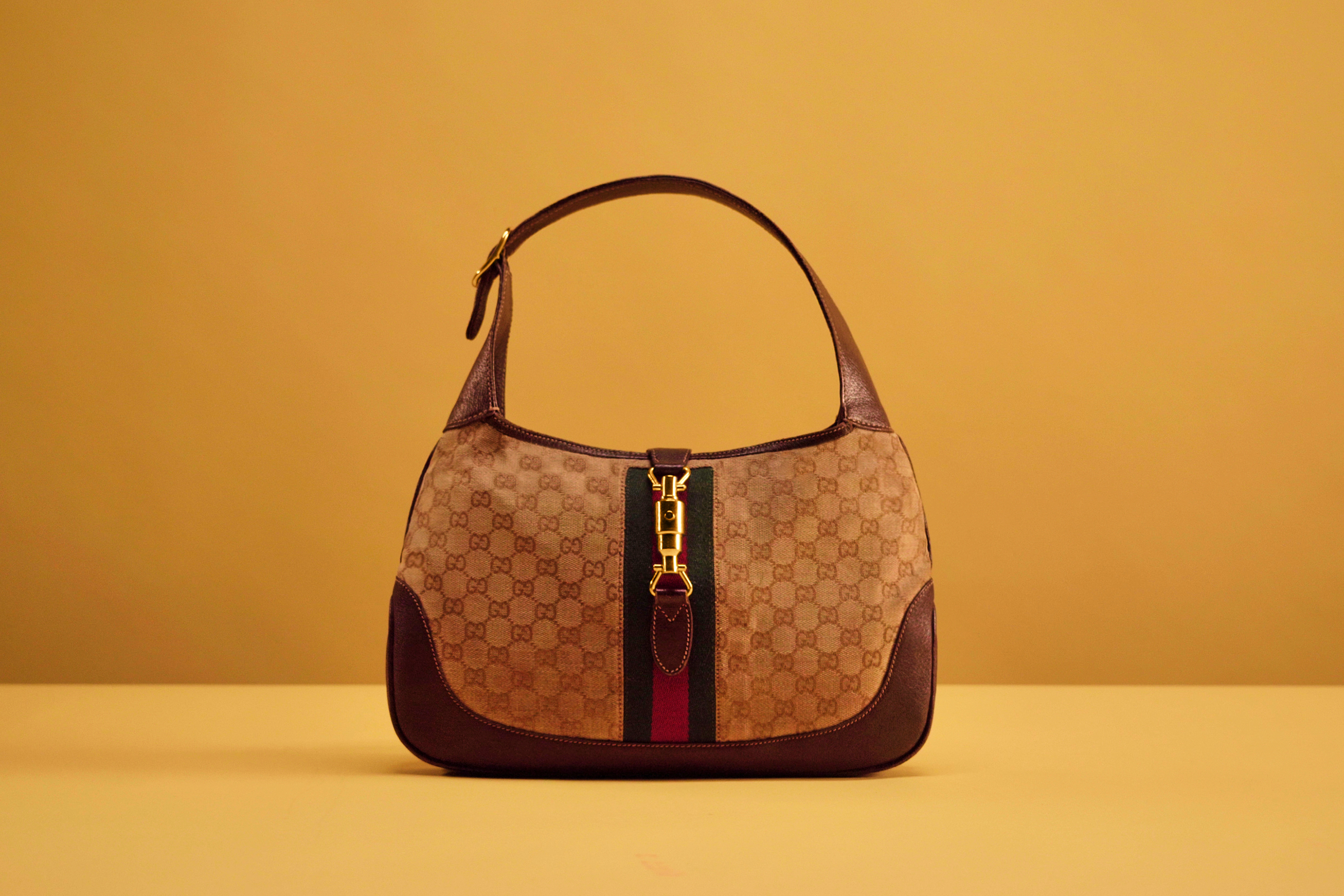 From the Gucci Archive, an early 1970s bag with shoulder strap in original GG fabric and brown boar with Web ribbon. Photo: Courtesy of Gucci Vault