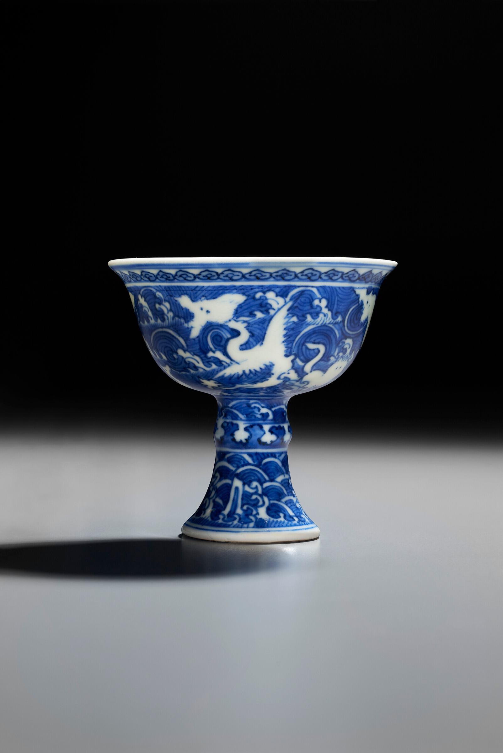 A very rare blue and white reverse-decorated stem cup, 1573-1620. 3¼ in (8.2 cm) diameter. Estimate: $300,000-500,000. Offered in Marchant: Eight Treasures for the Wanli Emperor on 21 September 2023 at Christie’s in New York