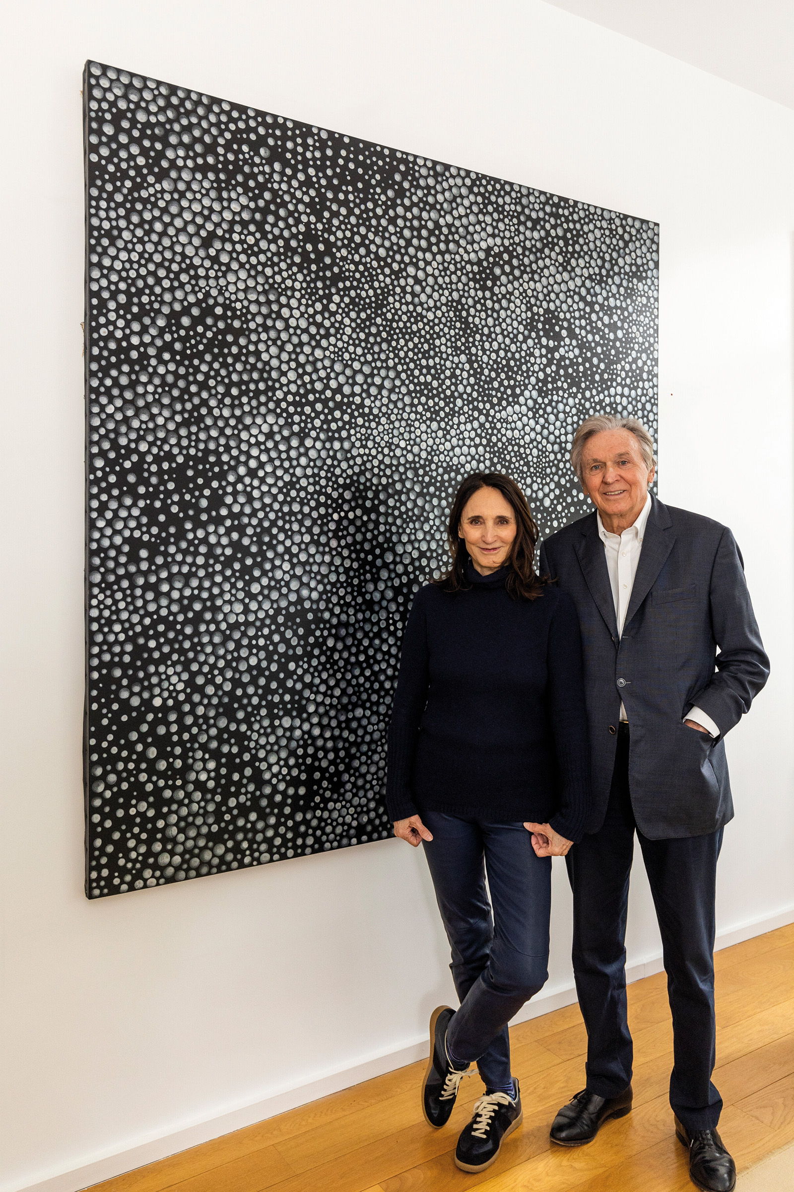 Anne and Wolfgang Titze in Paris, 2023, alongside Yayoi Kusama’s Dots-obsession [QZBA], 2007. The work is offered in LOVE STORIES — from the collection of Anne & Wolfgang Titze on 19 October 2023 at Christie's in Paris