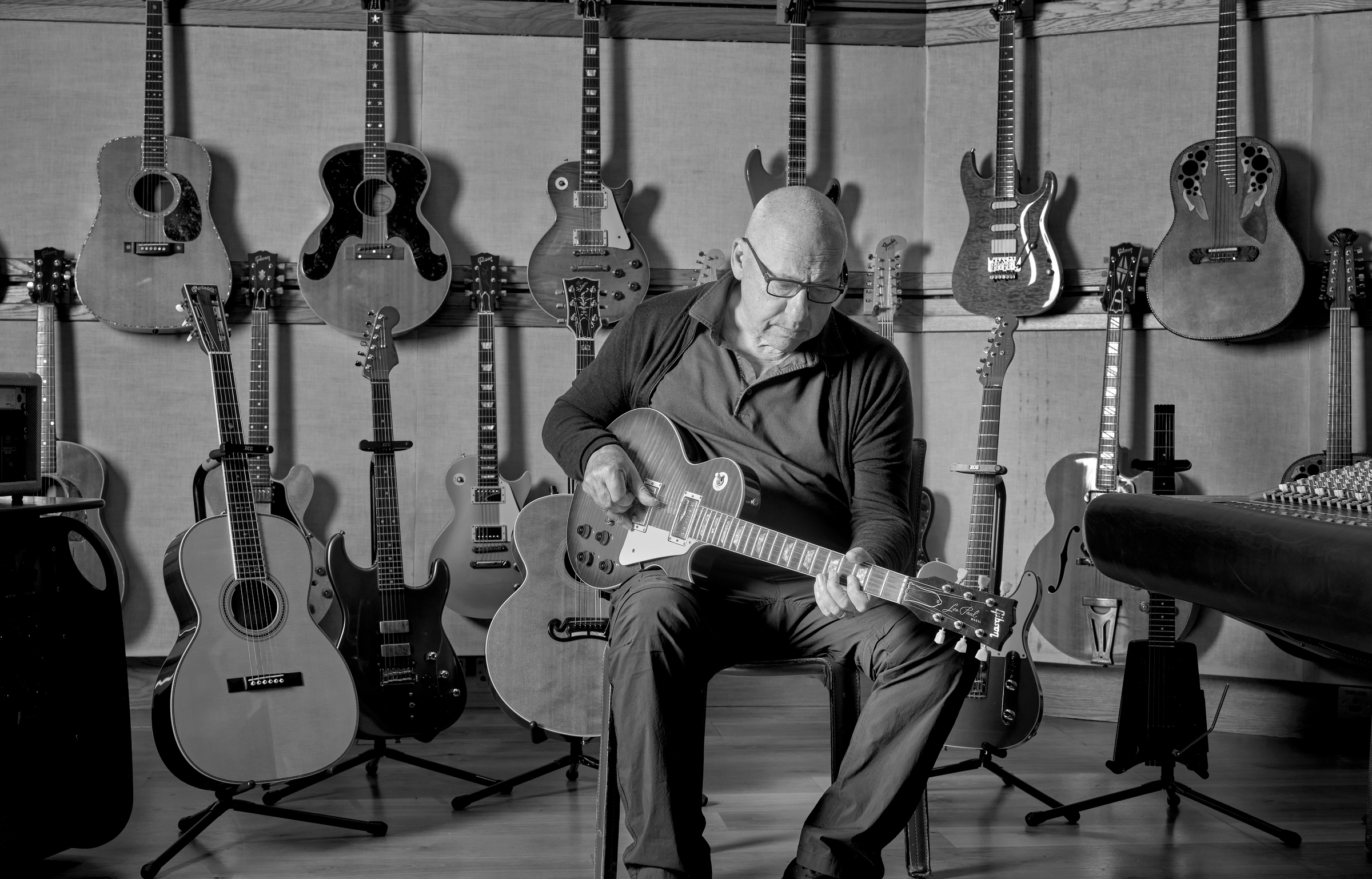 Mark Knopfler and a selection of the guitars included in the sale, photographed at British Grove Studios, London, 2023