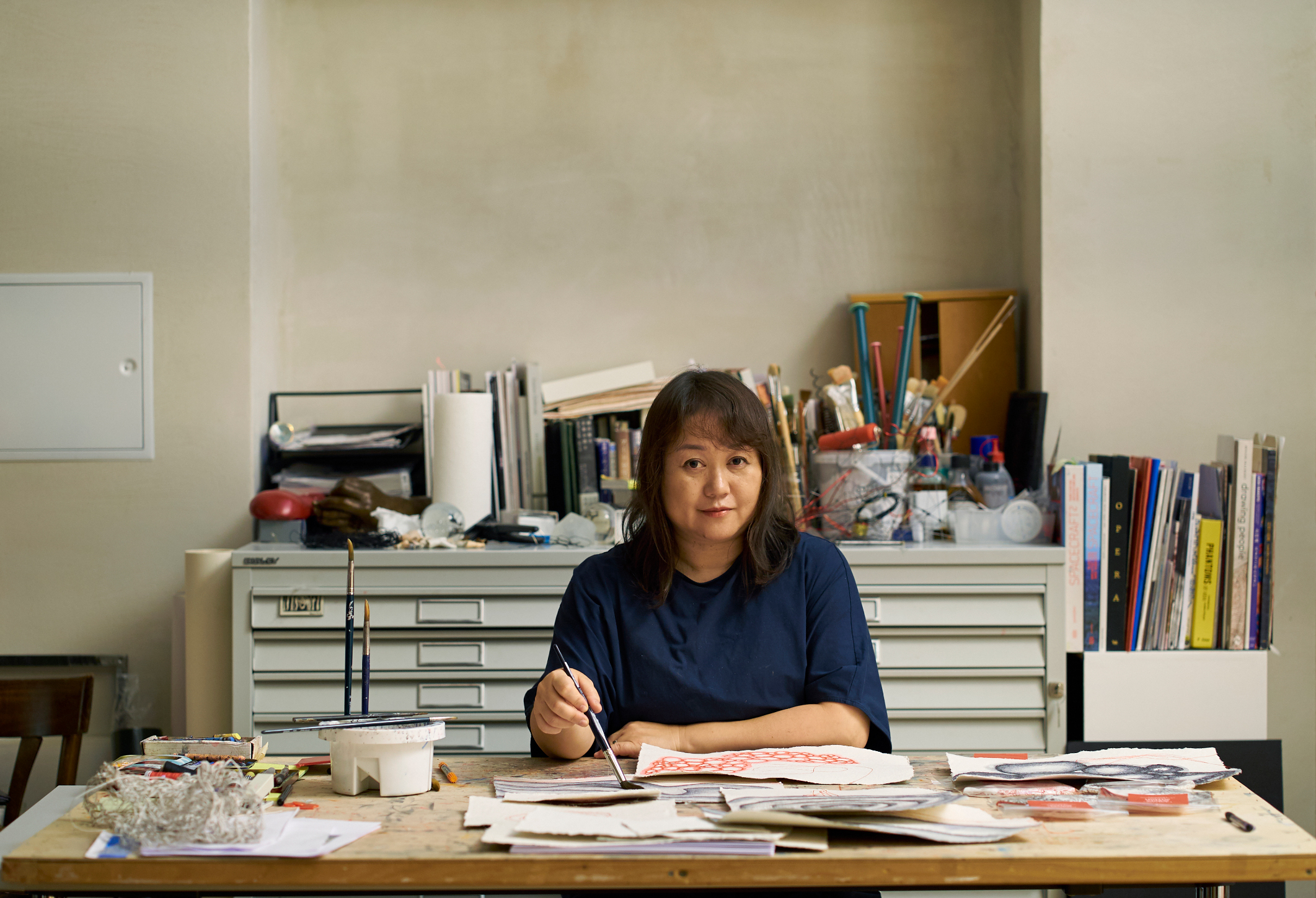 Chiharu Shiota in her studio. Her artwork for Chateau Mouton Rothschild shows four threads emerging from a solitary figure, representing the four seasons. 'It is like preserving the memory of the year in the wine,' she says