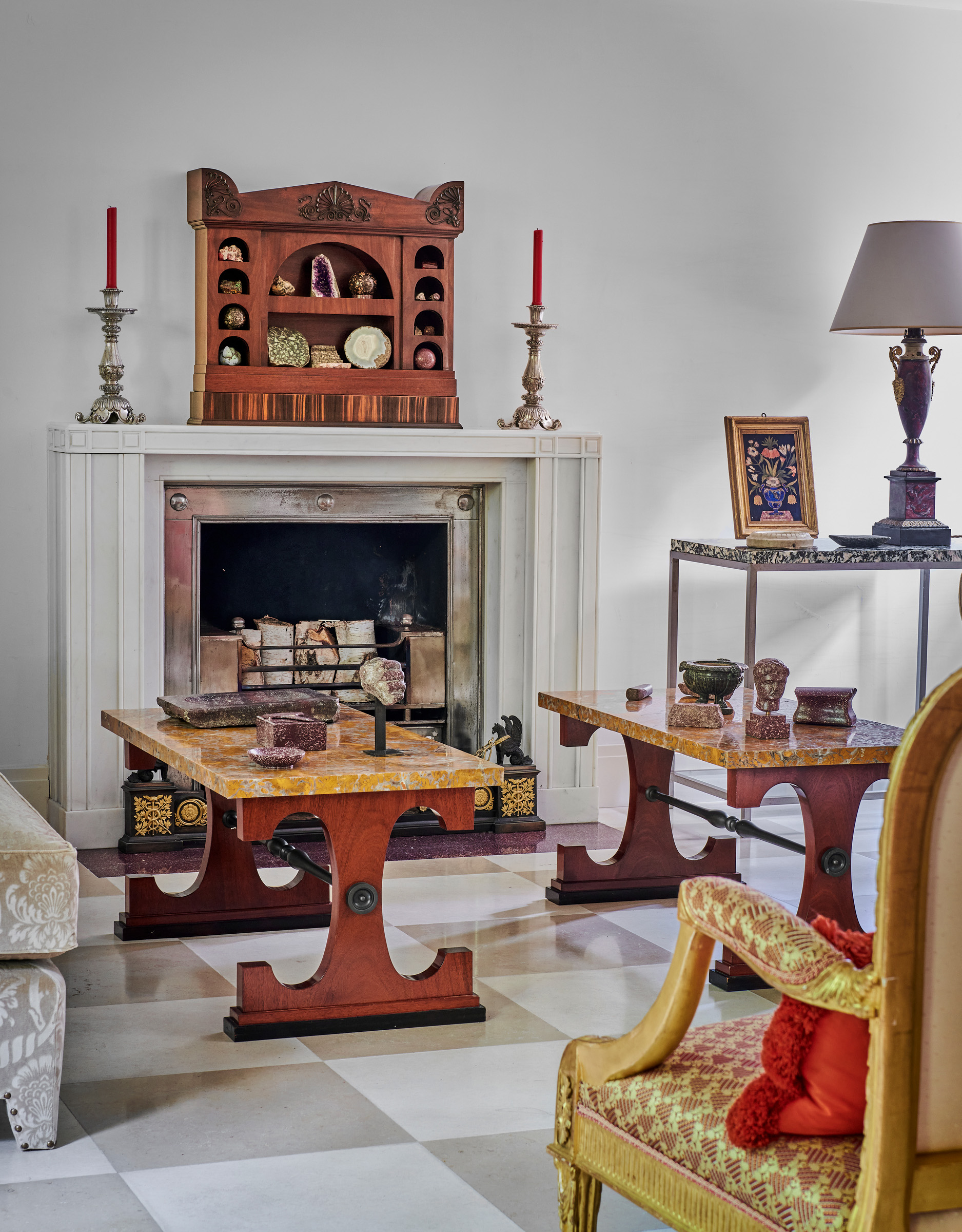 Flanked by a pair of Victorian silver candlesticks, a Regency mahogany cabinet or ‘recess’, circa 1800, designed by Thomas Hope for his London residence, adorns the mantlepiece in Philip Hewat-Jaboor's drawing room among other objects offered at Christie's in London