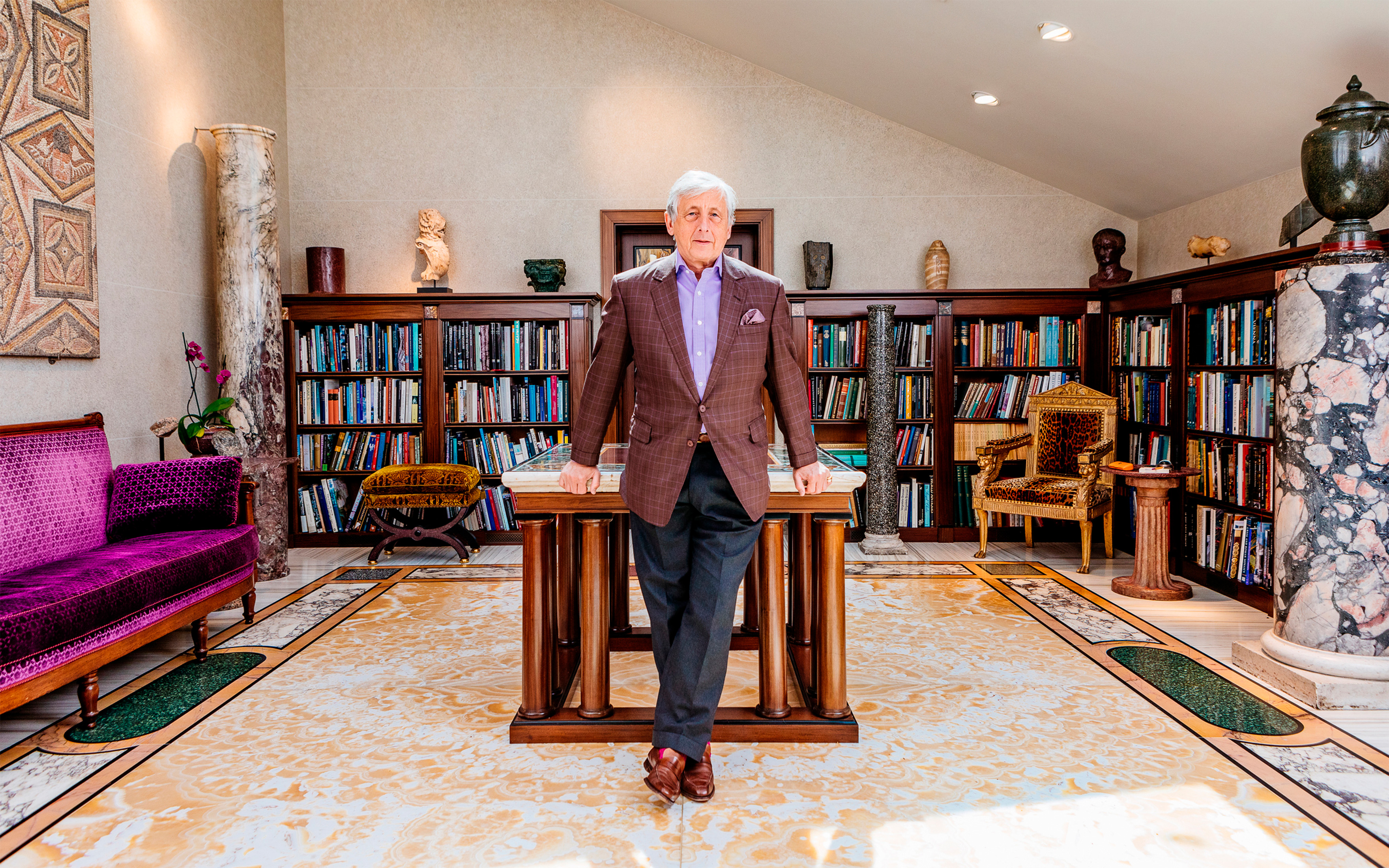 Philip Hewat-Jaboor in his library on the island of Jersey, surrounded by objects offered in the collection
