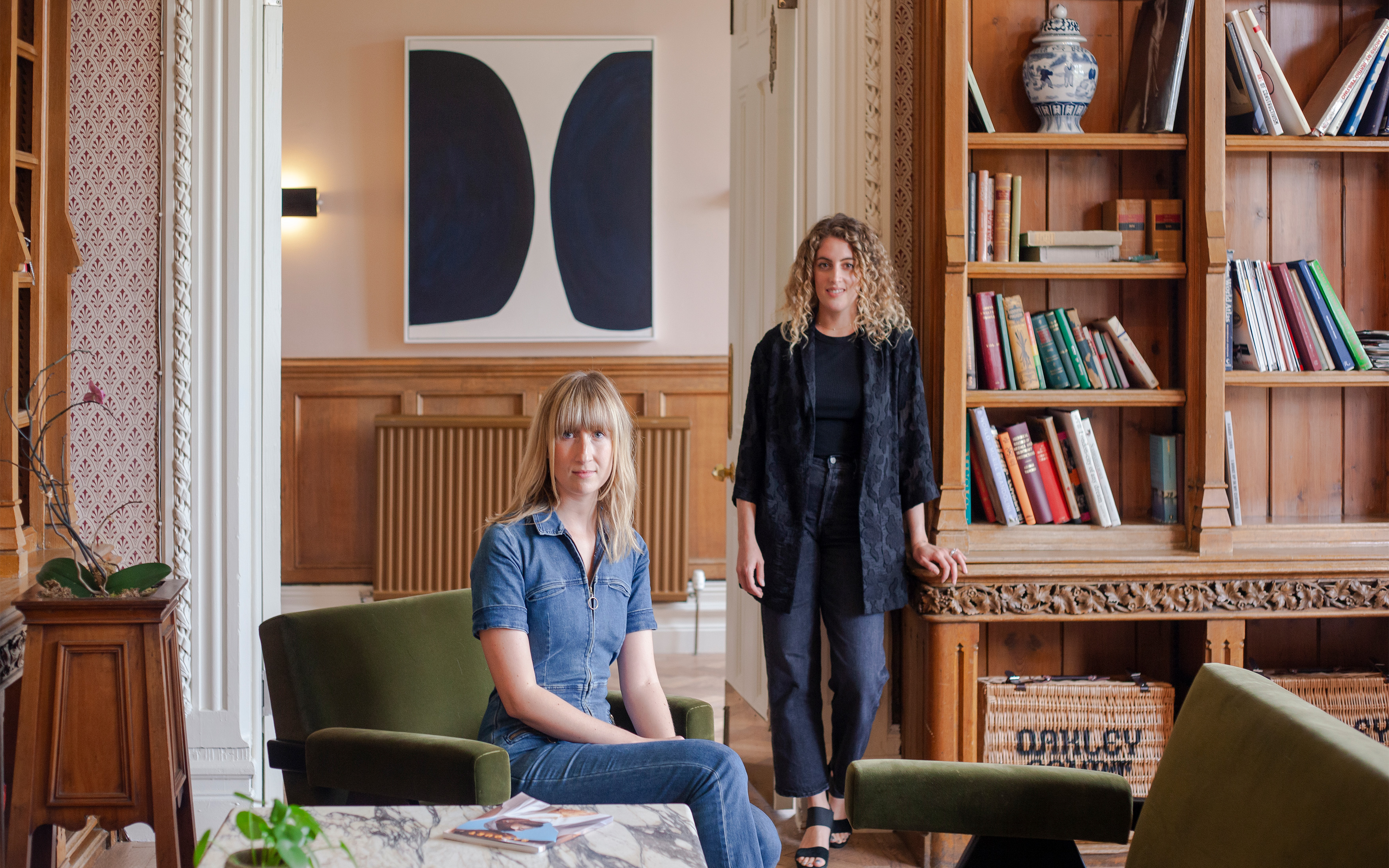 CURA Art founders Georgia Powell (left) and Liza Shapiro in the library at Oakley Court in Berkshire, England