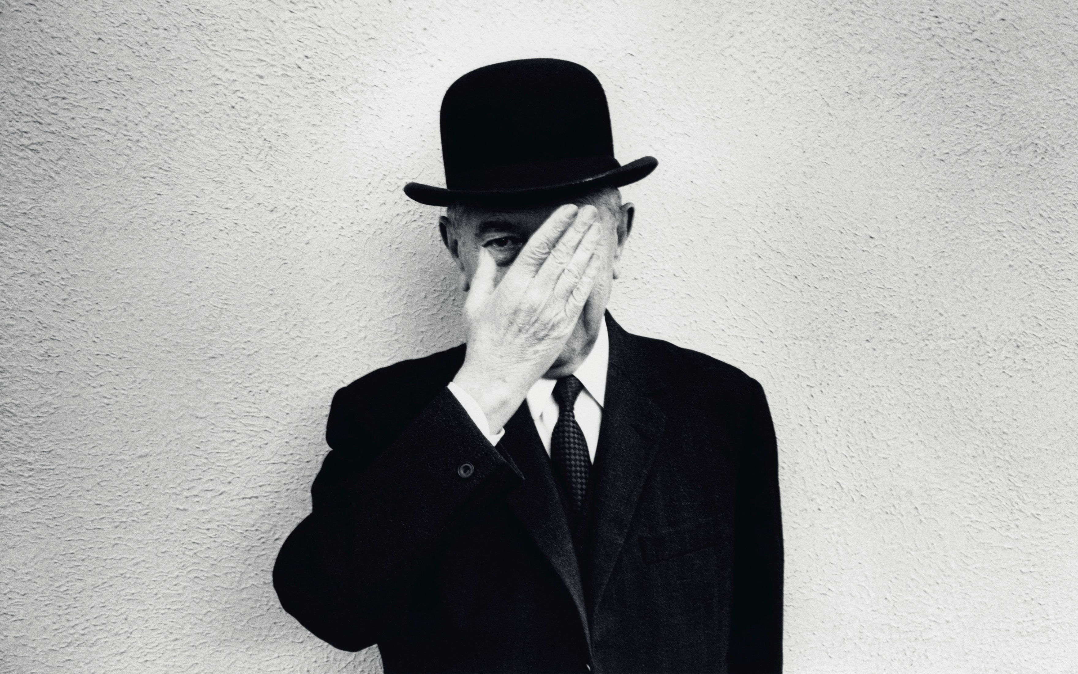 Rene Magritte photographed in his signature bowler hat in 1965