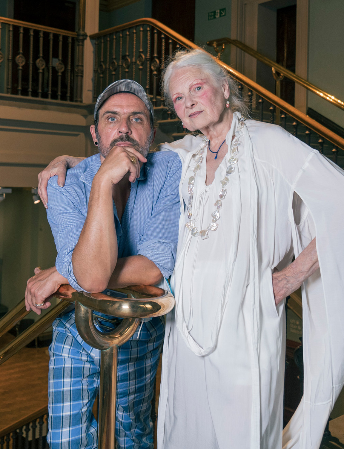 Vivienne Westwood and Andreas Kronthaler photographed at the Victoria and Albert Museum, London. Westwood is wearing a white viscose Knocker dress from the Andreas Kronthaler for Vivienne Westwood Rock Me Amadeus Collection, Spring-Summer 2020