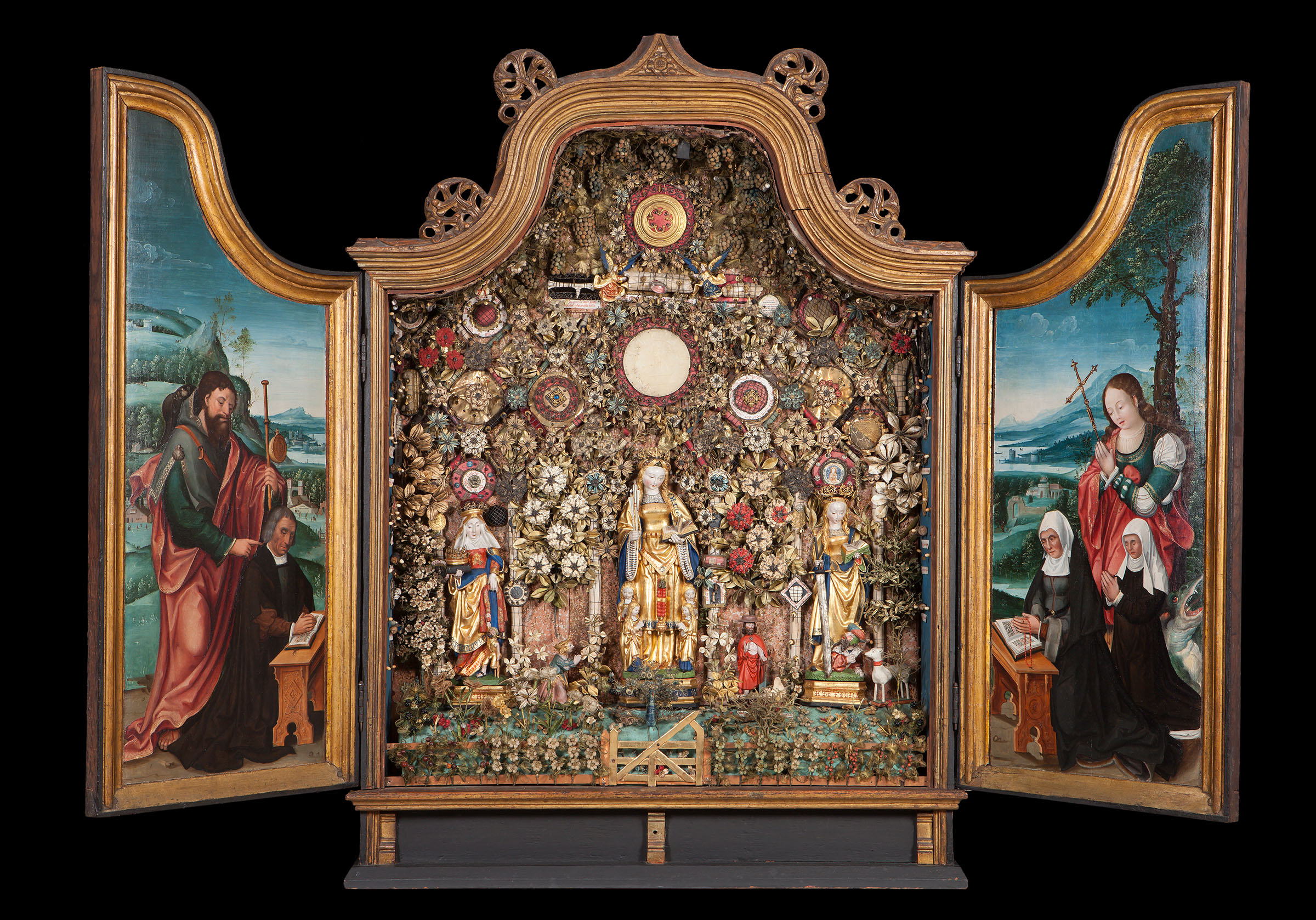 Enclosed Garden showing Saints Elizabeth, Ursula and Catherine, 16th century. Museum Hof van Busleyden, Mechelen, Belgium. Enclosed Gardens were a form of religious art that emerged in the Low Countries in the late Middle Ages. These richly stocked cabinets depicting gardens of paradise were embellished with silk flowers, wooden sculptures, medallions, relics and inscriptions