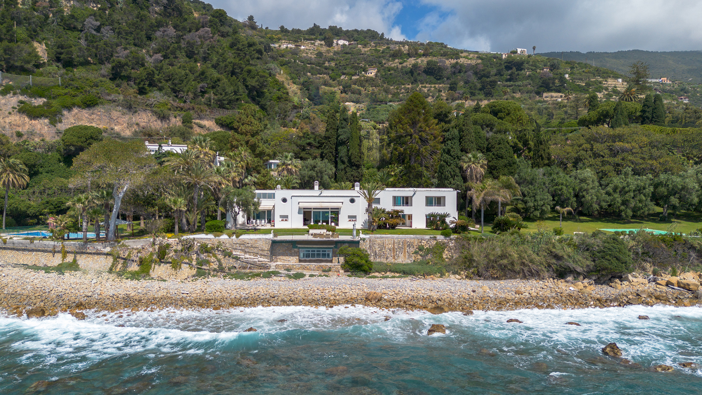 A travertine walkway designed by Gio Ponti overlooks the villa's 850ft-long private stretch of coastline