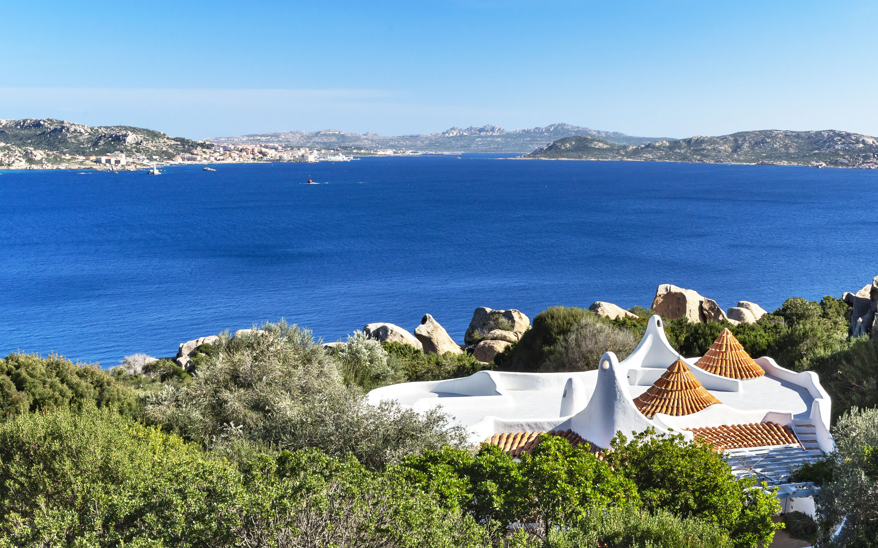 The Ulivi Estate includes two villas, landscaped gardens, and a private stretch of the coast of Sardinia