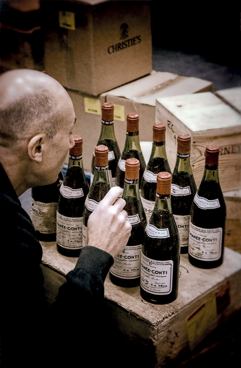 Tim Triptree MW inspecting bottles of Romanee-Conti from a collection that had been kept for decades in an old air-raid shelter in southern England