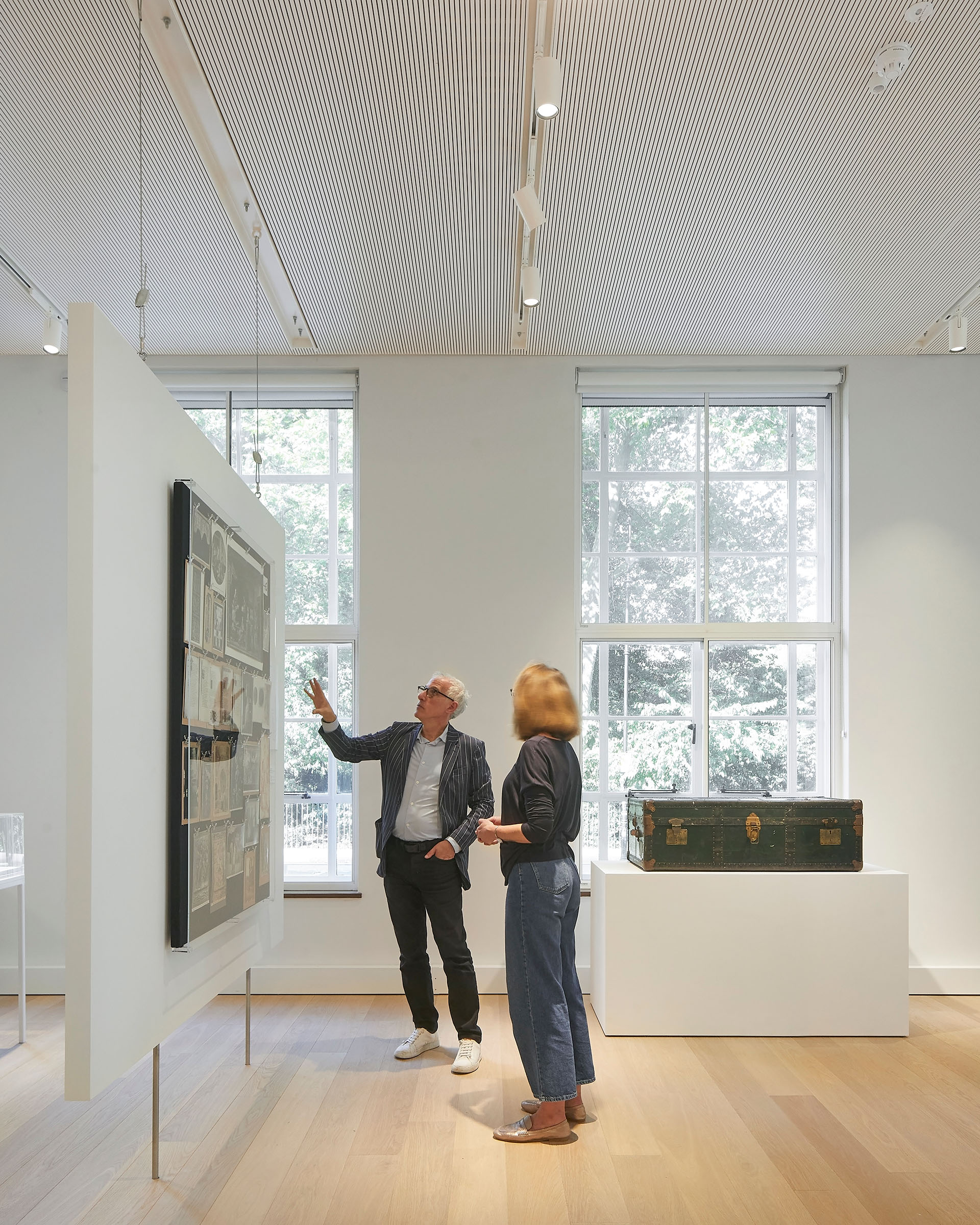Director Bill Sherman with a visitor in the Kythera Gallery at the Warburg Institute, in front of a panel from the Bilderatlas Mnemosyne
