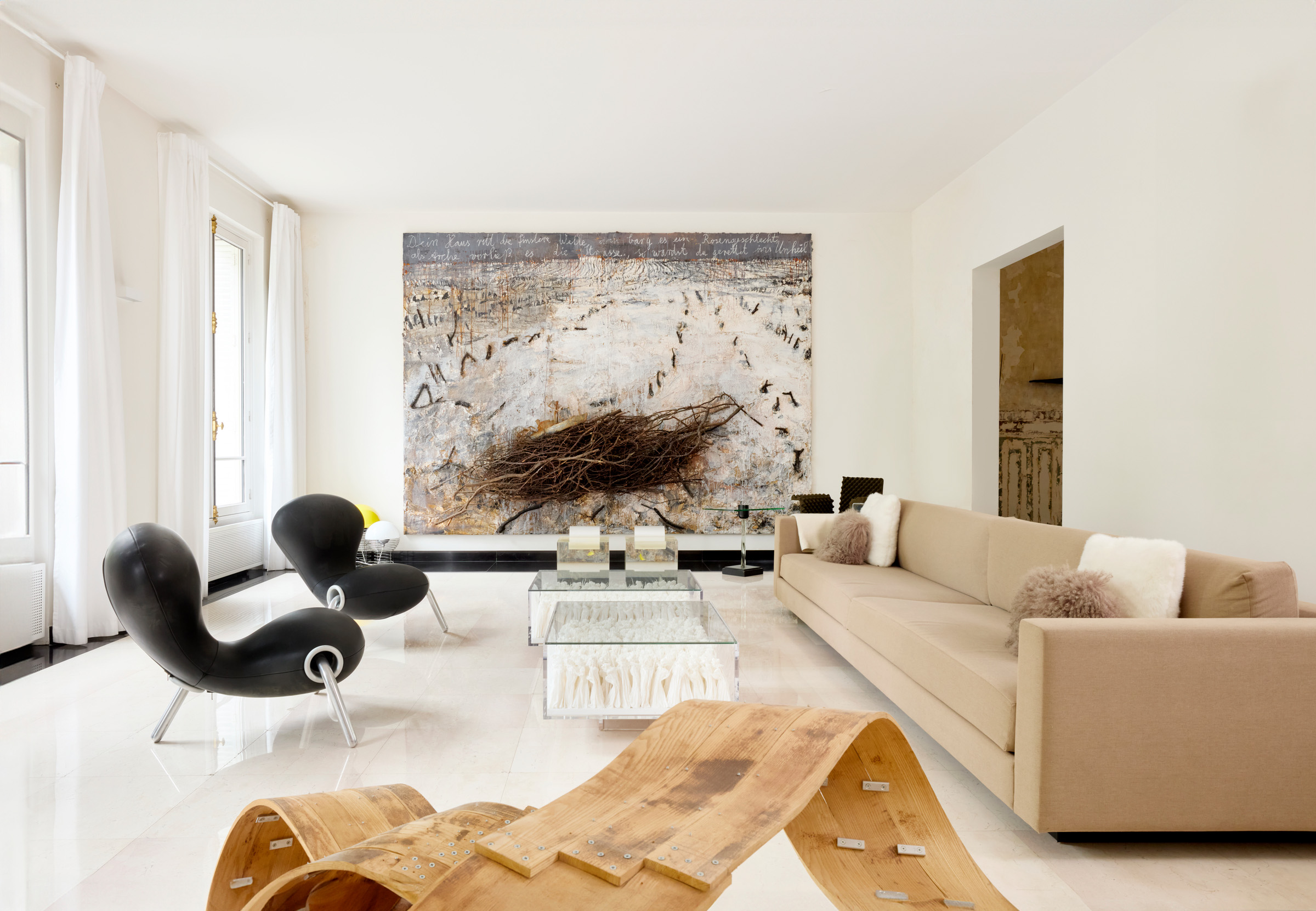 The Mallarts' Paris residence. In the foreground is a 2006 sculpture by Richard Deacon, UW84DC #16. Overlooking the room is a monumental 2006 canvas by Anselm Kiefer, Dein Haus ritt die finstere Welle. Both are offered in Collection Danute et Alain Mallart: Bruxelles - Paris - Vilnius on 17 October 2024 at Christie's in Paris