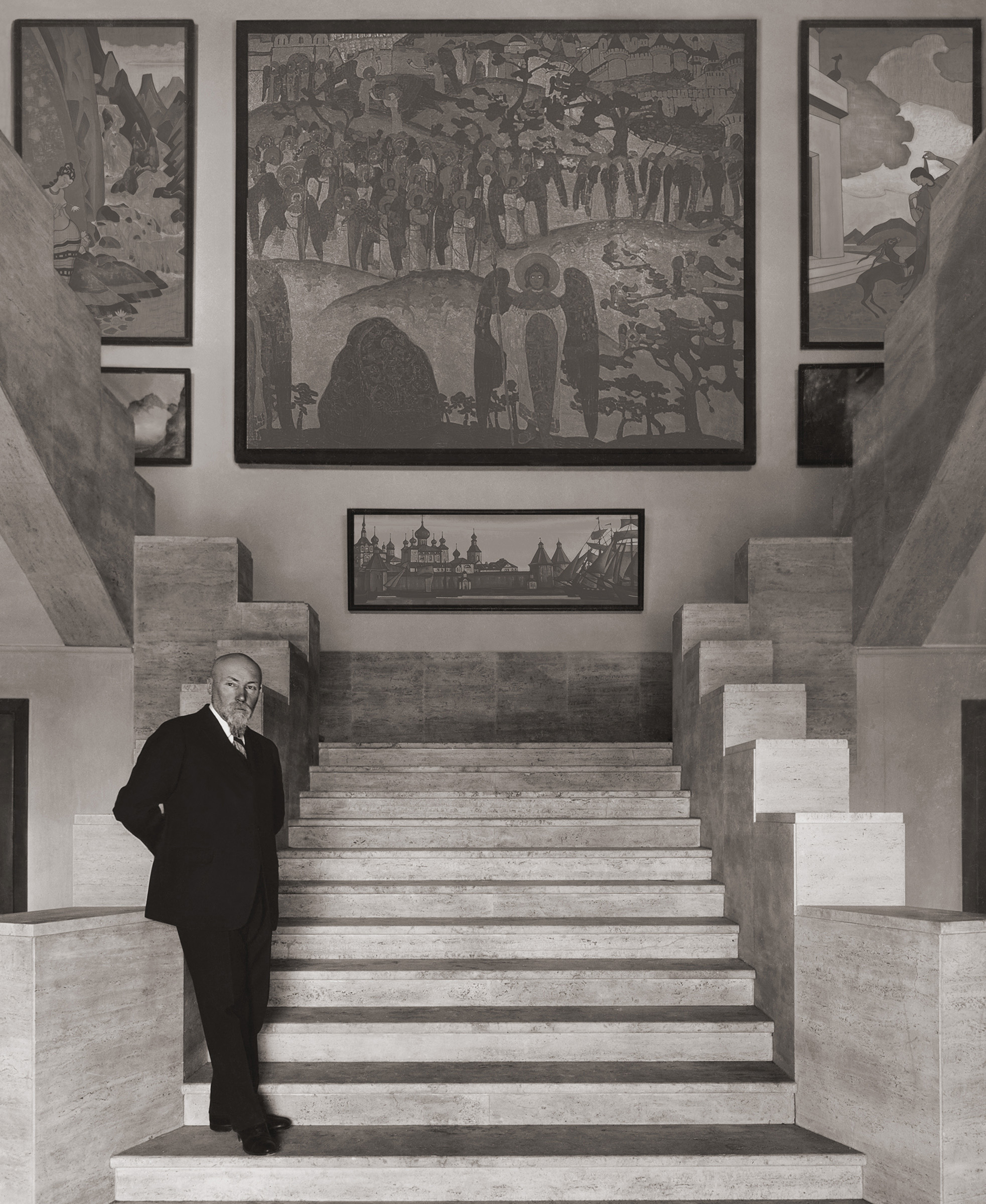 The artist in the entrance to the Master Building in New York, 1929. In the background are his works Treasure of the Angels, 1905, and Solovetsky Monastery, 1923