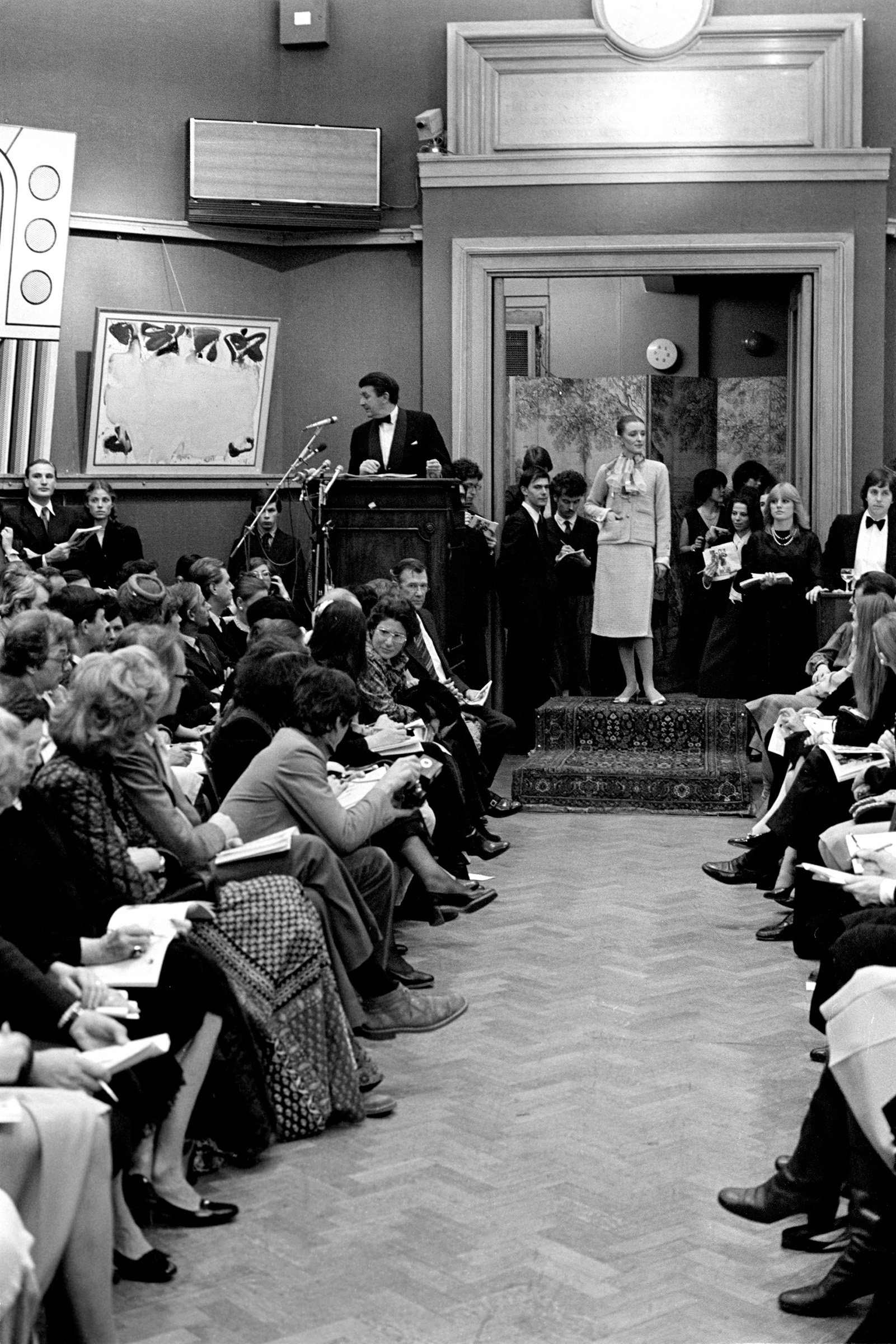 Victoria Wolcough during the auction at Christie’s, modelling lot 52 of the The Personal Collection of Chanel sale in 1978