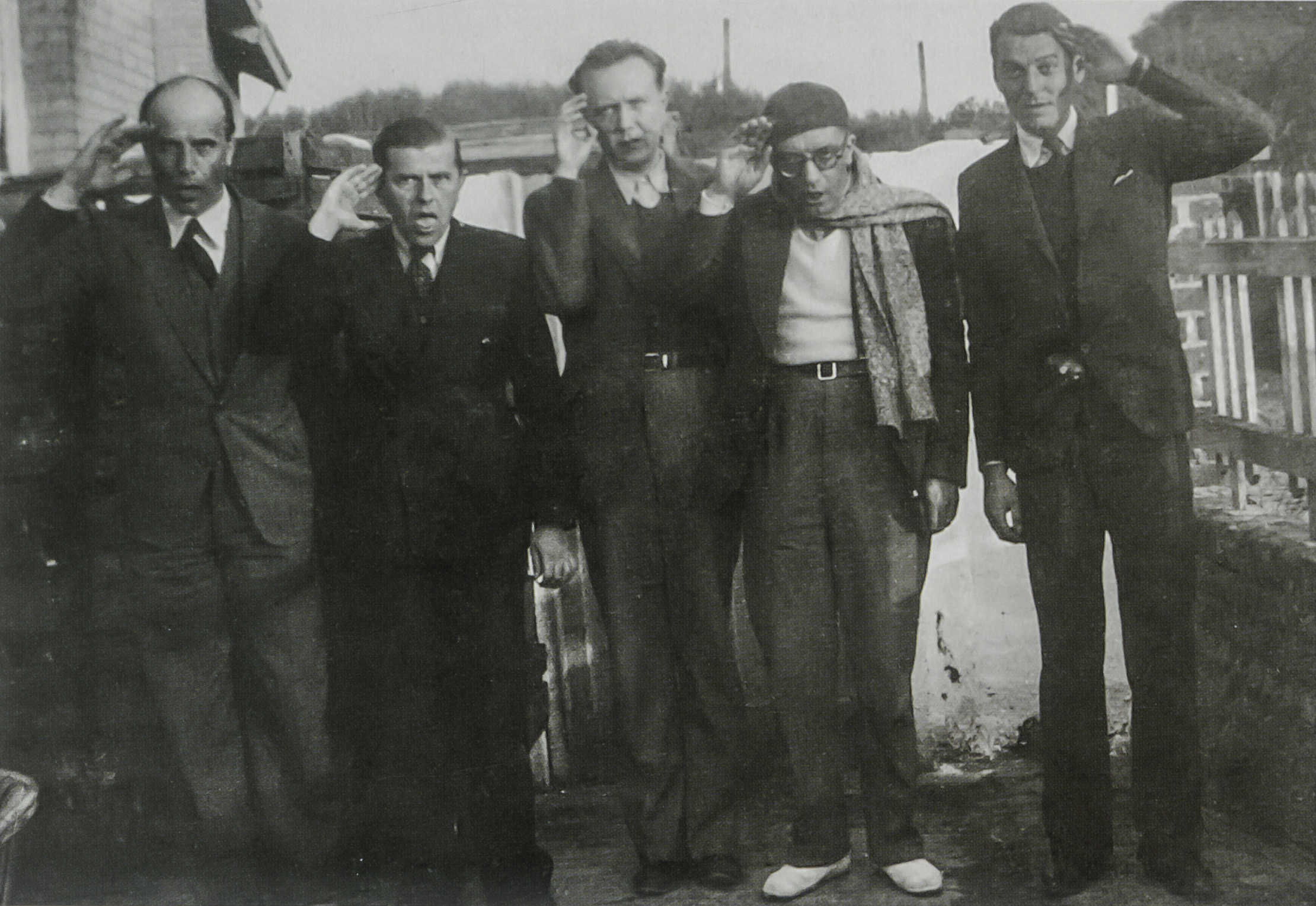 Saluting the flag - the Belgian Surrealist group in September 1935 at Coxyde, Belgium, photograph staged by Rene Magritte. From left: Paul Colinet, Rene Magritte, Louis Scutenaire, Paul Nouge and Paul Magritte