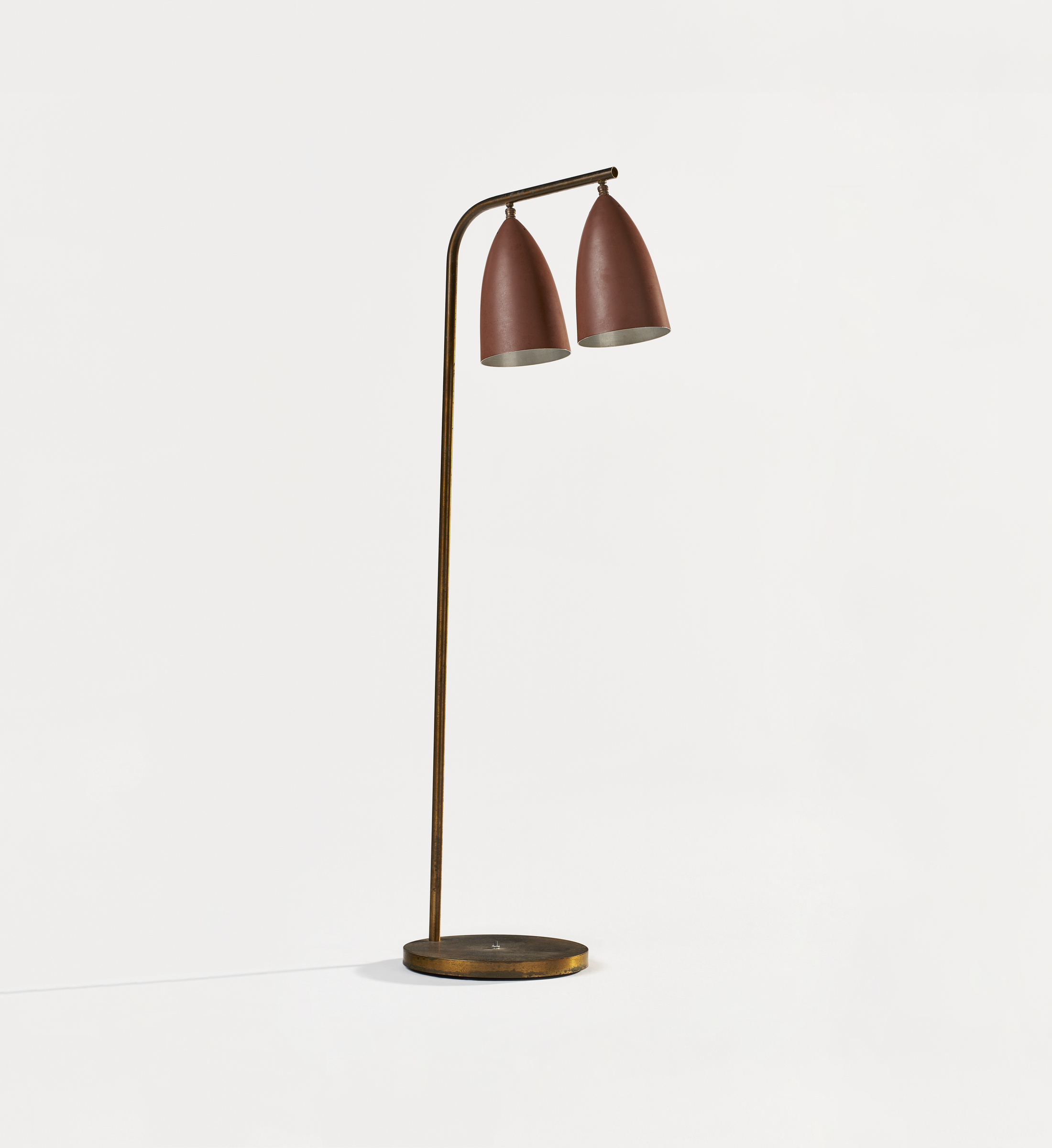 A modern floor lamp with a slender bronze body and two angled maroon shades.