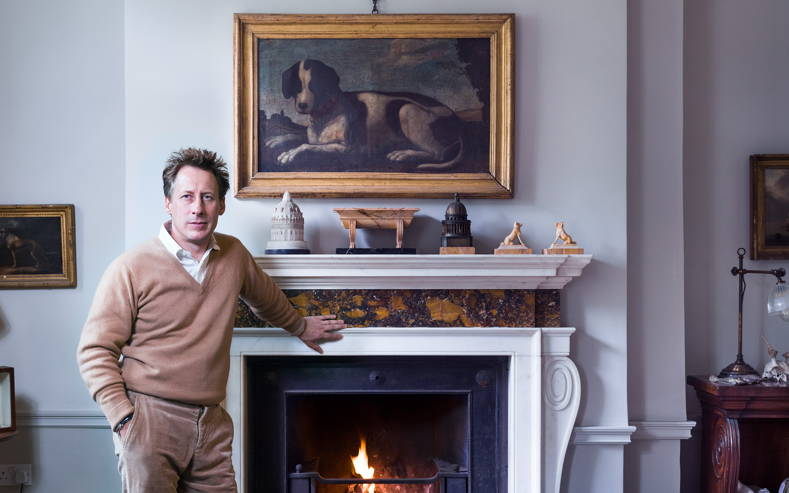Will Fisher at home with a 17th-century Italian painting of a dog by an unknown artist
