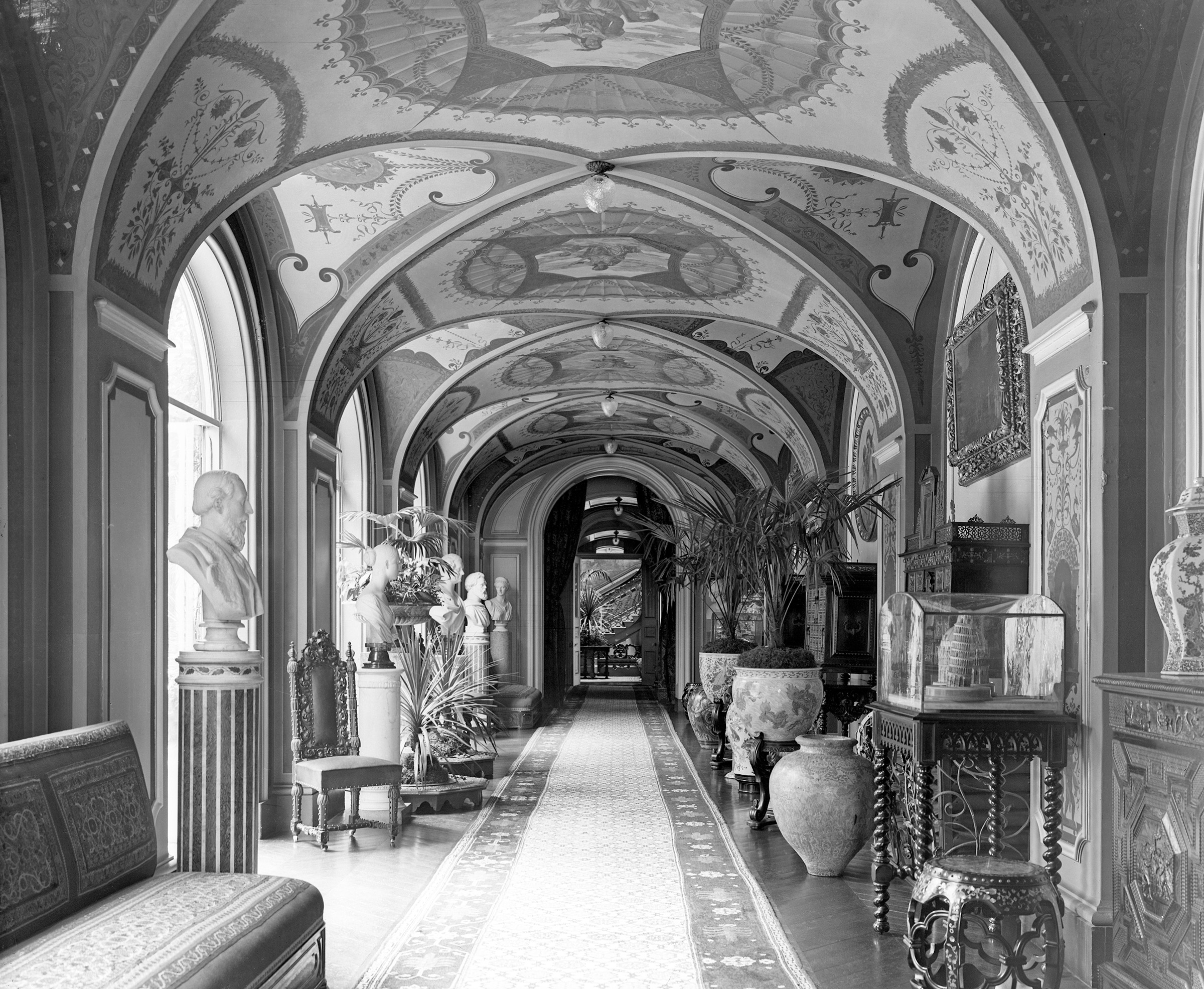 A corridor at Wimborne House, 22 Arlington Street, London, photographed in 1902. On the near and far left can be seen a pair of Italian scagliola columns, which sold for £40,320 on 9 April 2025 at Christie's Online