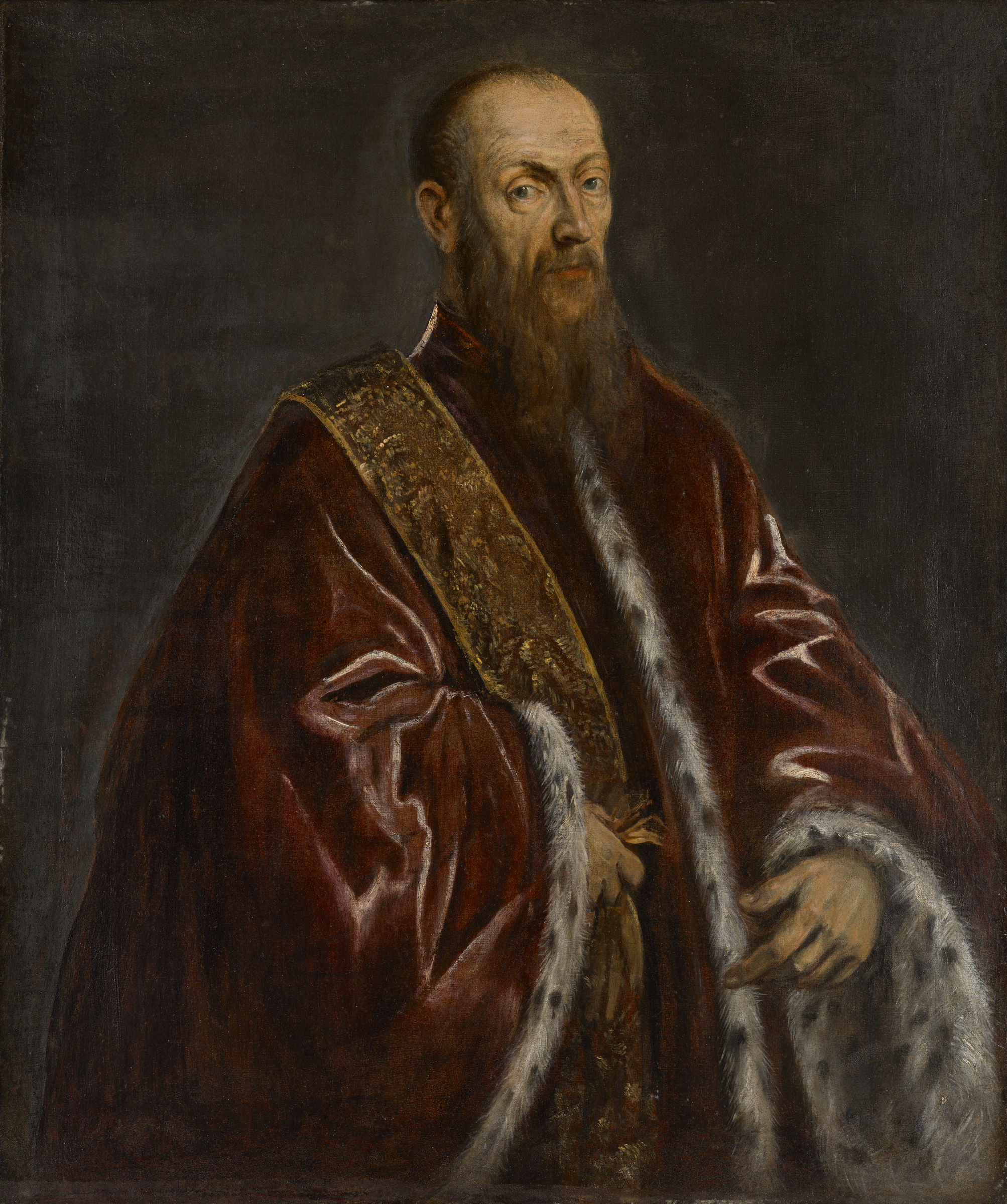The image shows a person wearing an opulent maroon robe with fur trim and a golden embroidered detail.