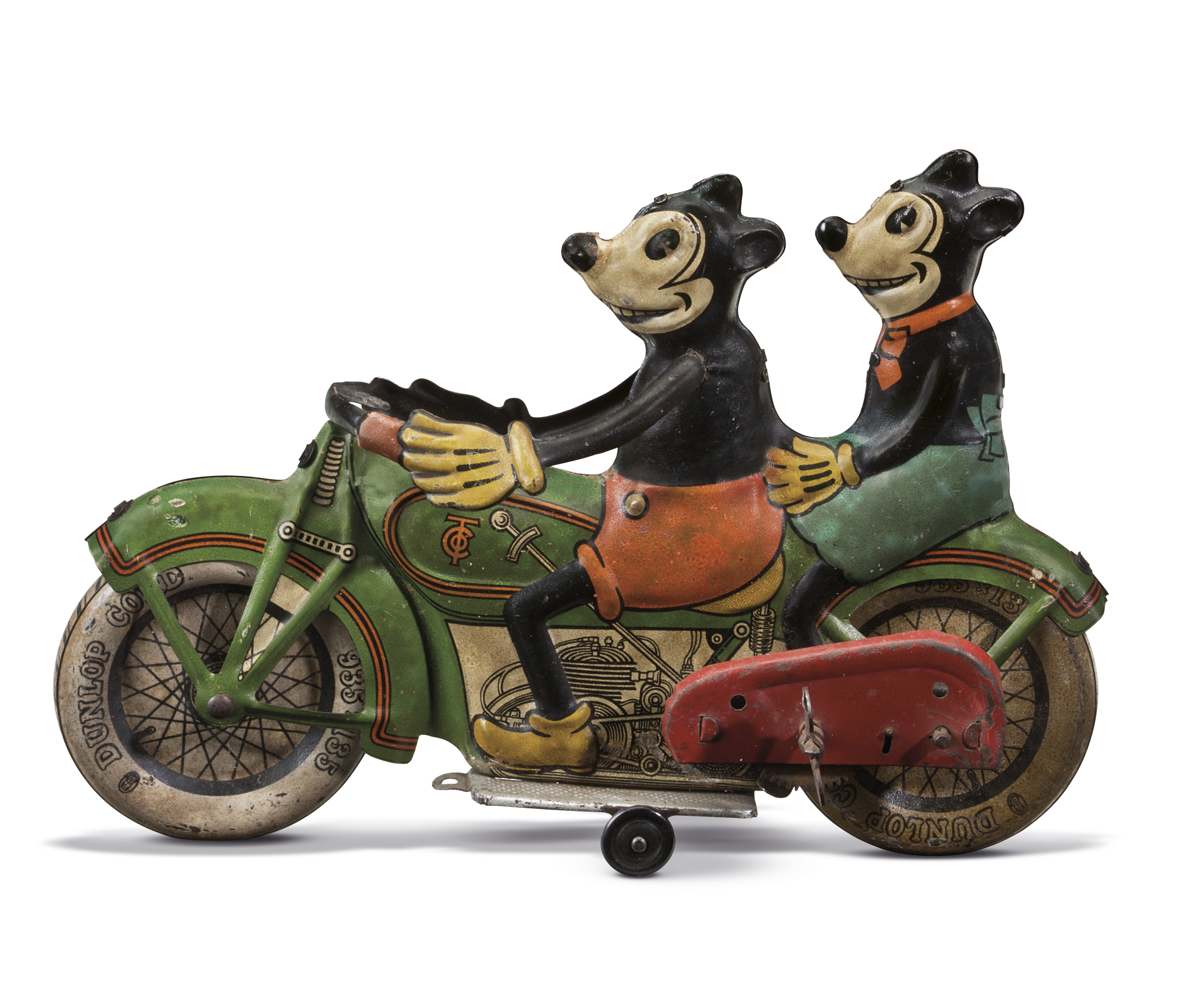 A vintage toy motorcycle carrying two cartoon-style animal characters, with one character driving and the other sitting behind.