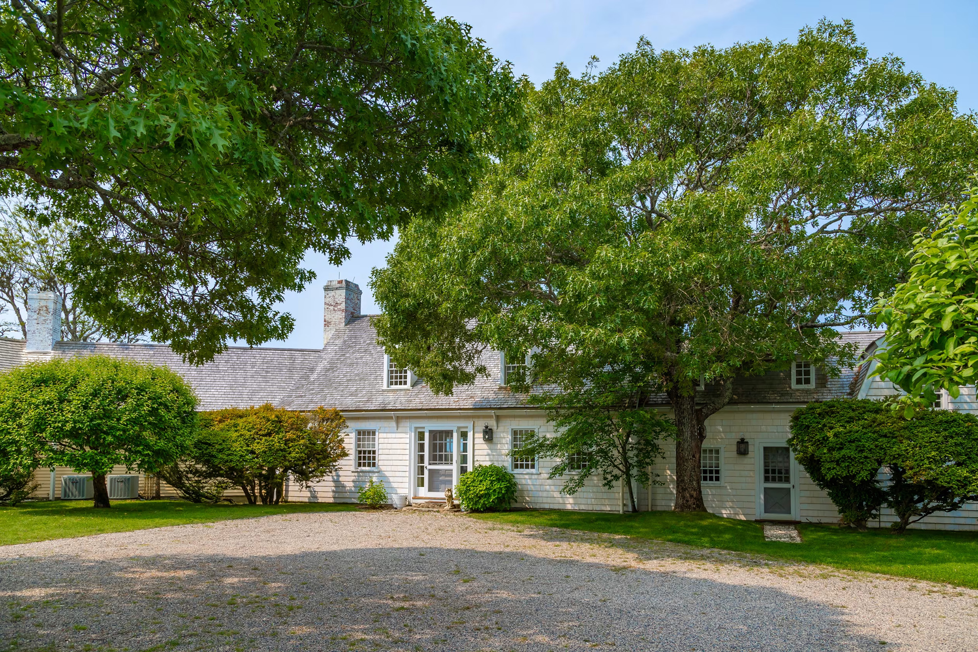 The Oyster Harbors house is built of concrete to withstand the salt air, the house is clad with wooden shingles in the traditional New England style