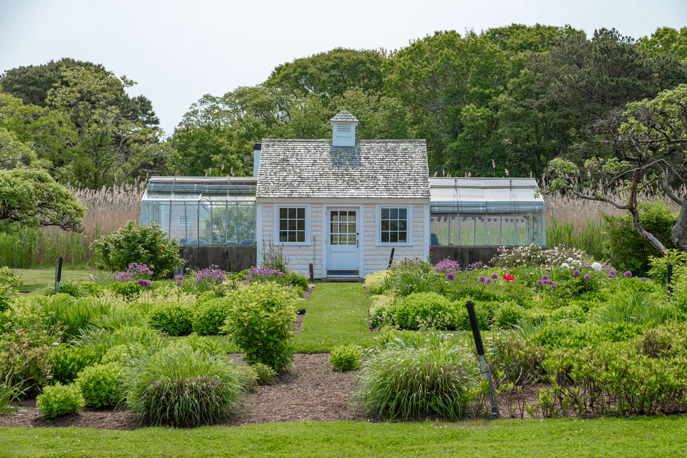 The property features two guest cottages, an artist's studio, a beach house and a greenhouse, in addition to extensive gardens reflecting Bunny Mellon's horticultural interests