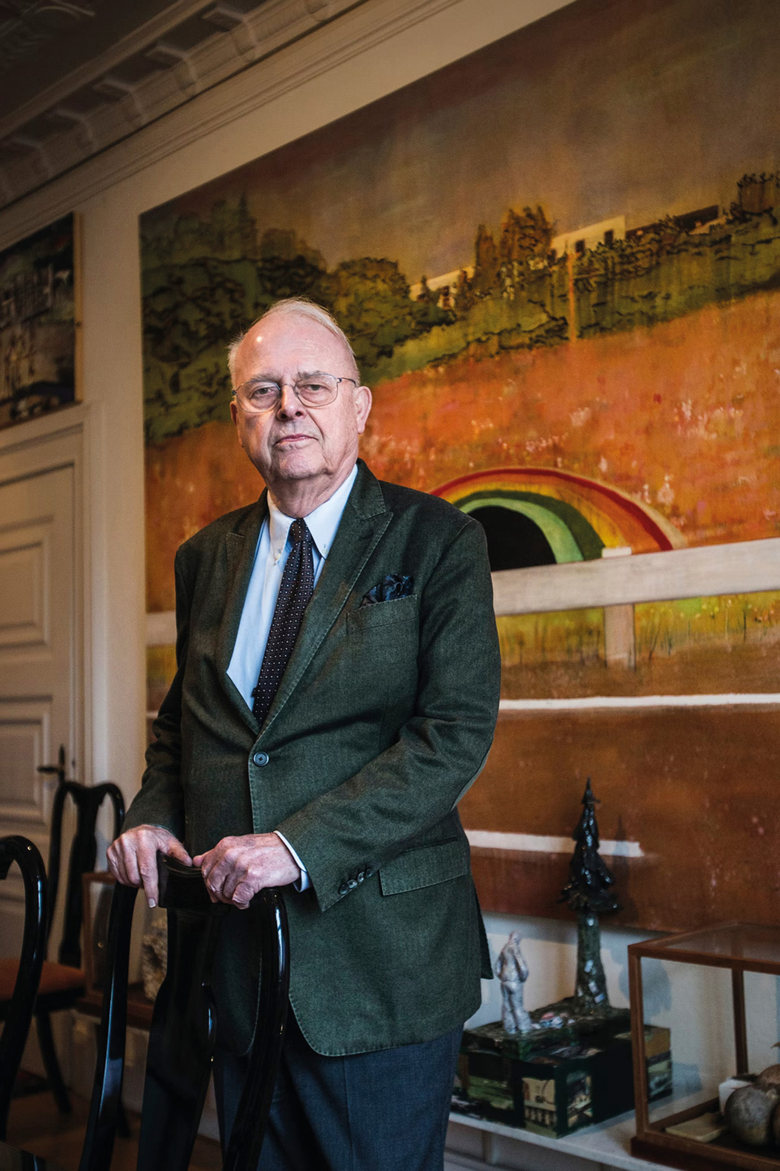 Ole Faarup at home, with a partial view of Peter Doig's Country Rock, 1998-99, offered in the 20th/21st Century: London Evening Sale on 15 October 2025 at Christie's in London. Doig was among the artists that Faarup counted as a friend