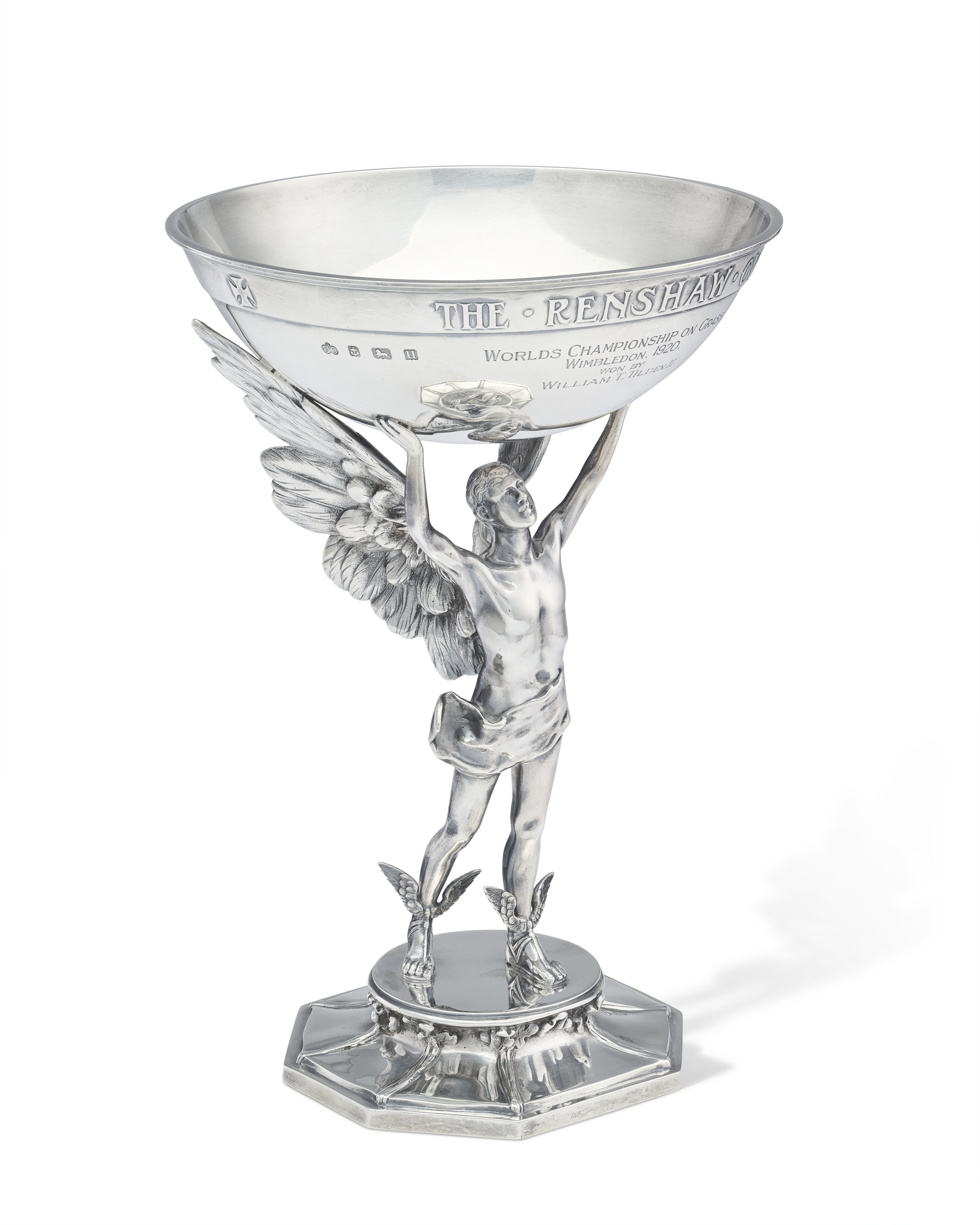 Silver trophy featuring an angelic figure holding up a bowl engraved with "The Renshaw" and text commemorating a championship.