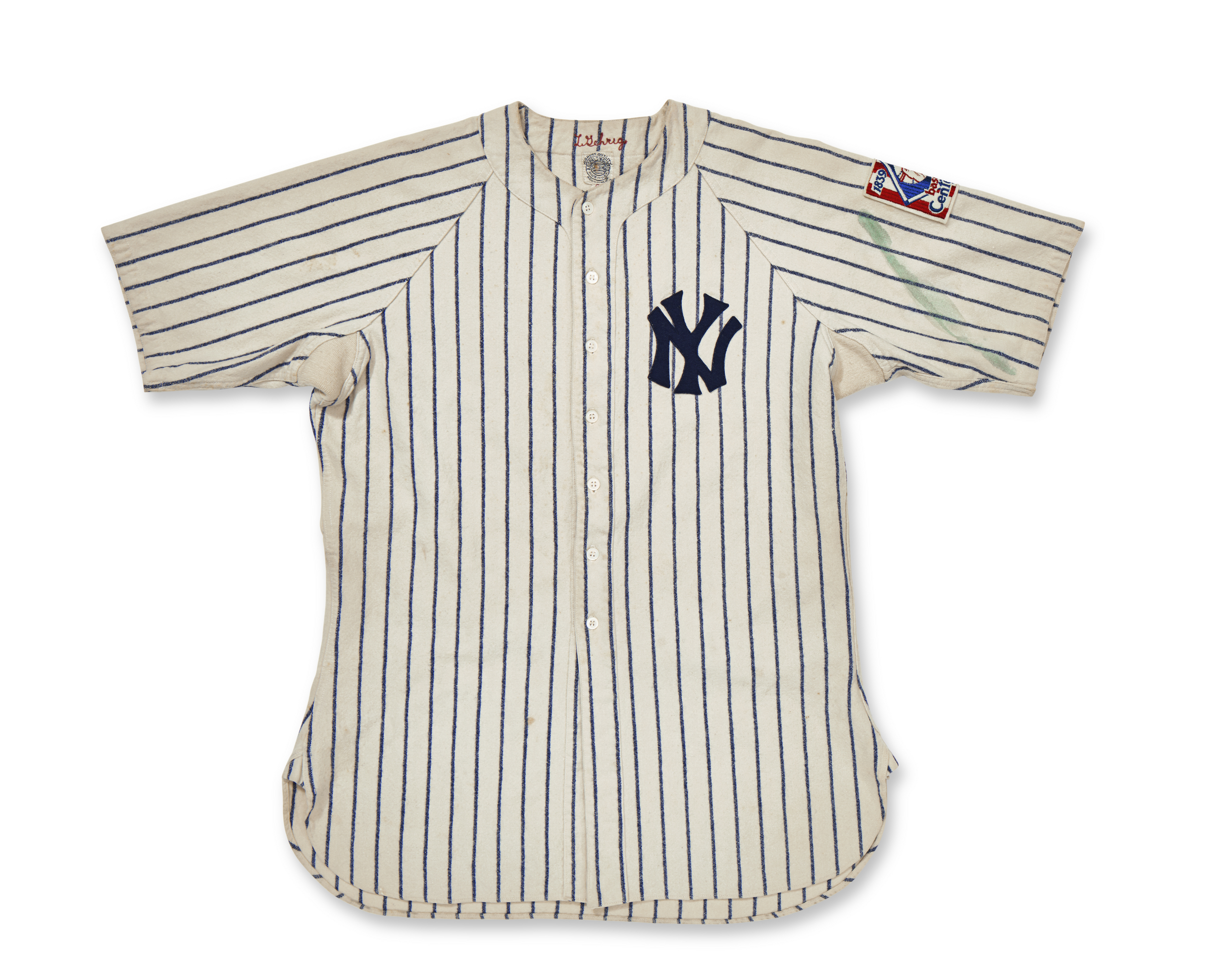 A vintage New York Yankees baseball jersey with pinstripes and an emblem on the sleeve.