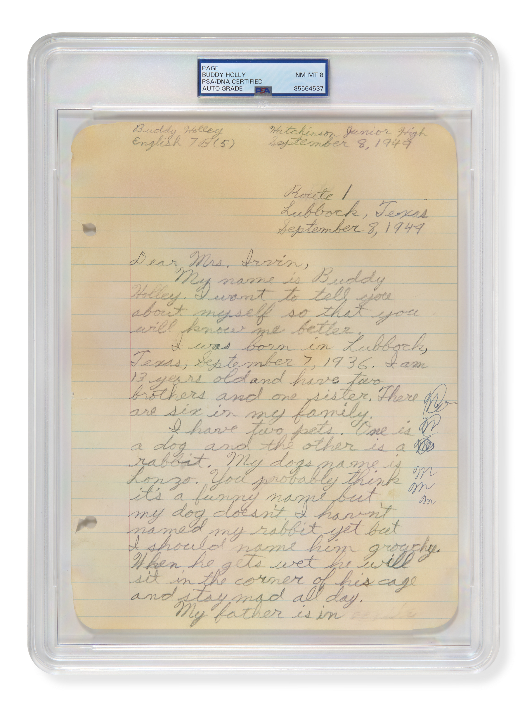 An encased handwritten essay by Buddy Holly dated September 8, 1949, on a yellowed notebook page, describing his family and pets.