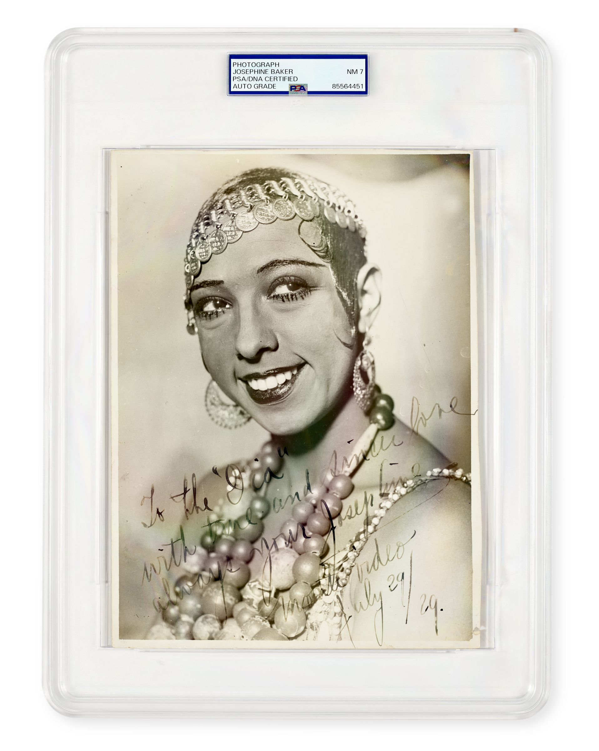 The image shows a vintage photograph in a plastic sleeve with a handwritten note and a collection of pearls and beads.