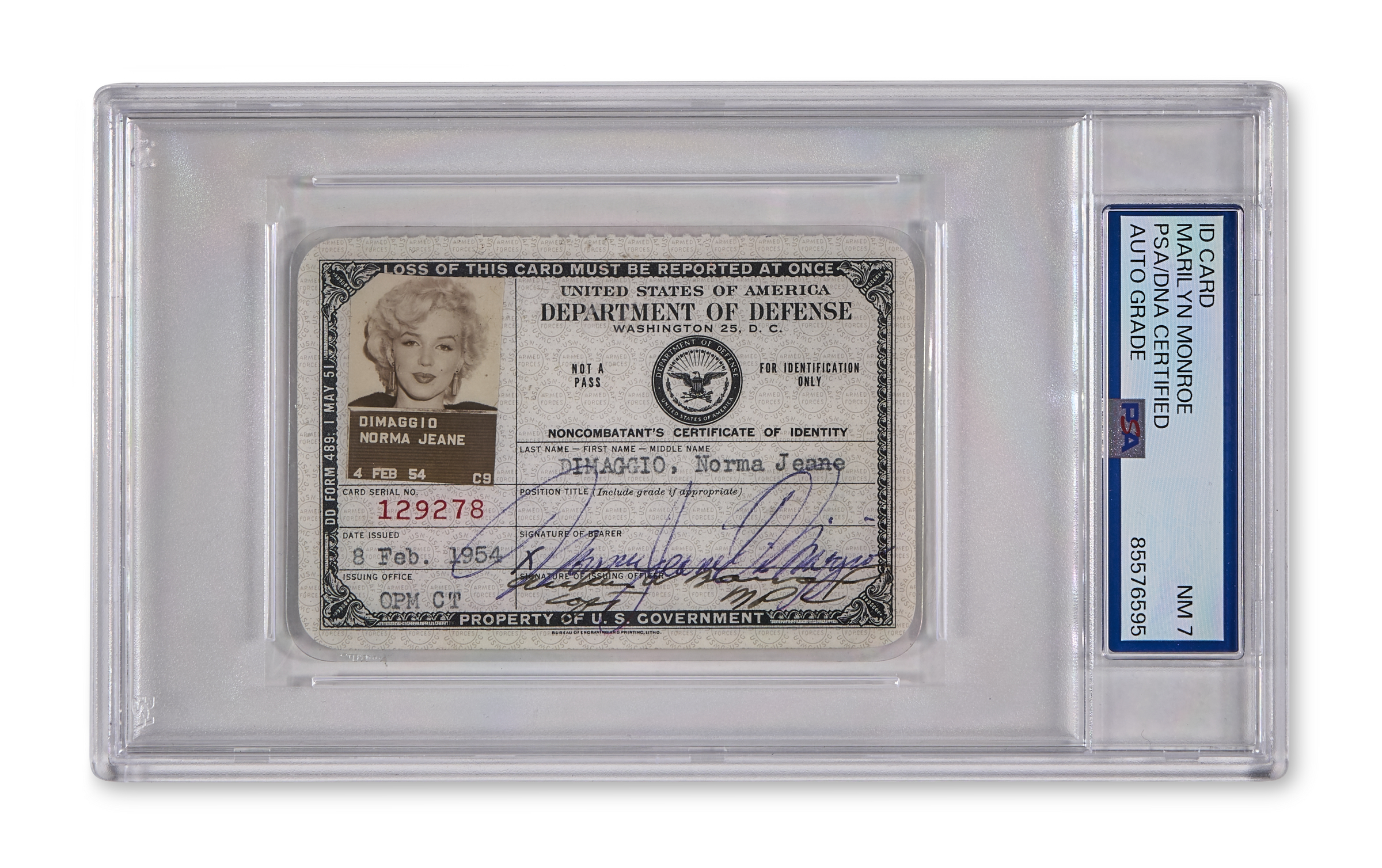 The image shows a vintage identification card in a protective case, labeled as a property of the U.S. Department of Defense.