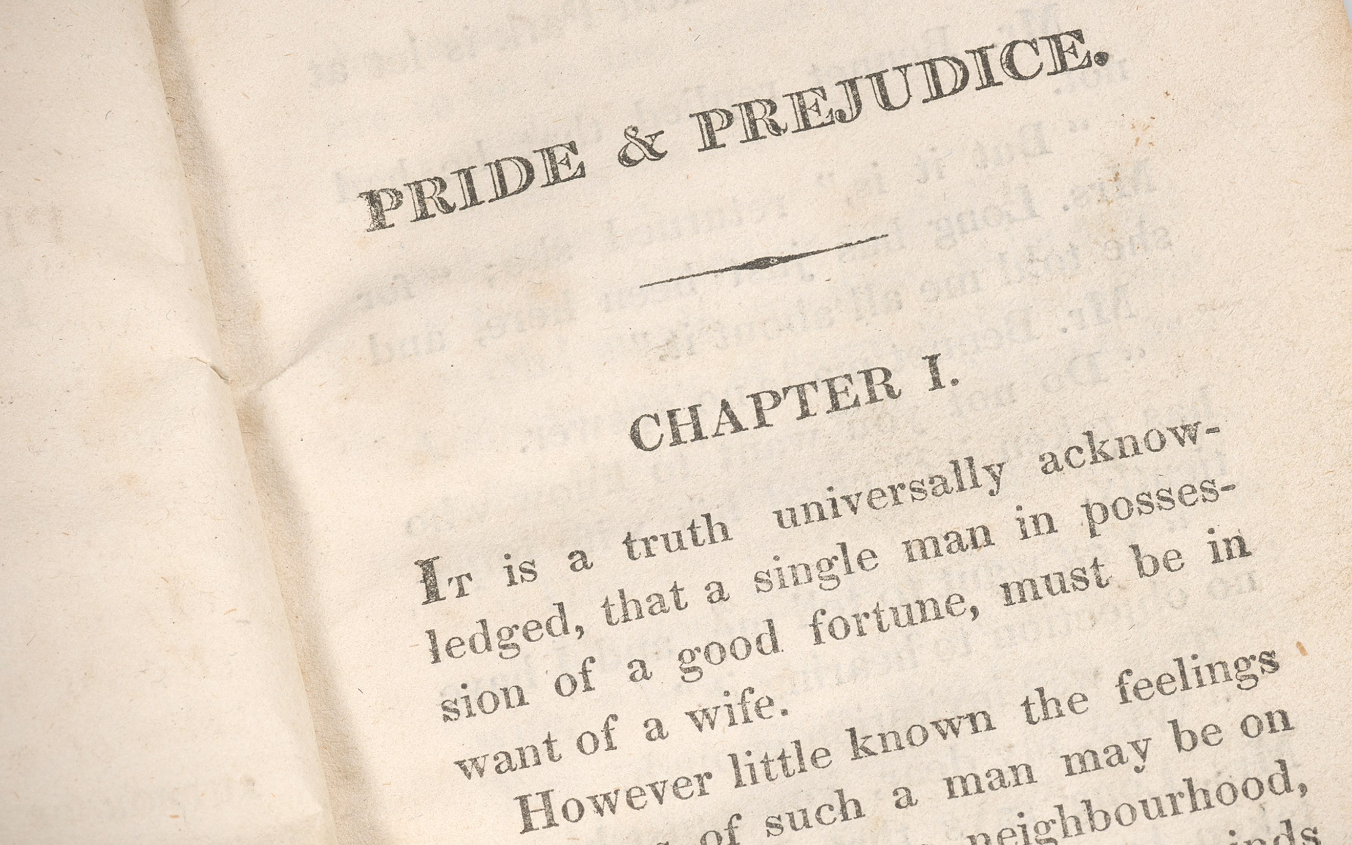 An open book displaying the title "Pride & Prejudice" and the beginning of Chapter I.