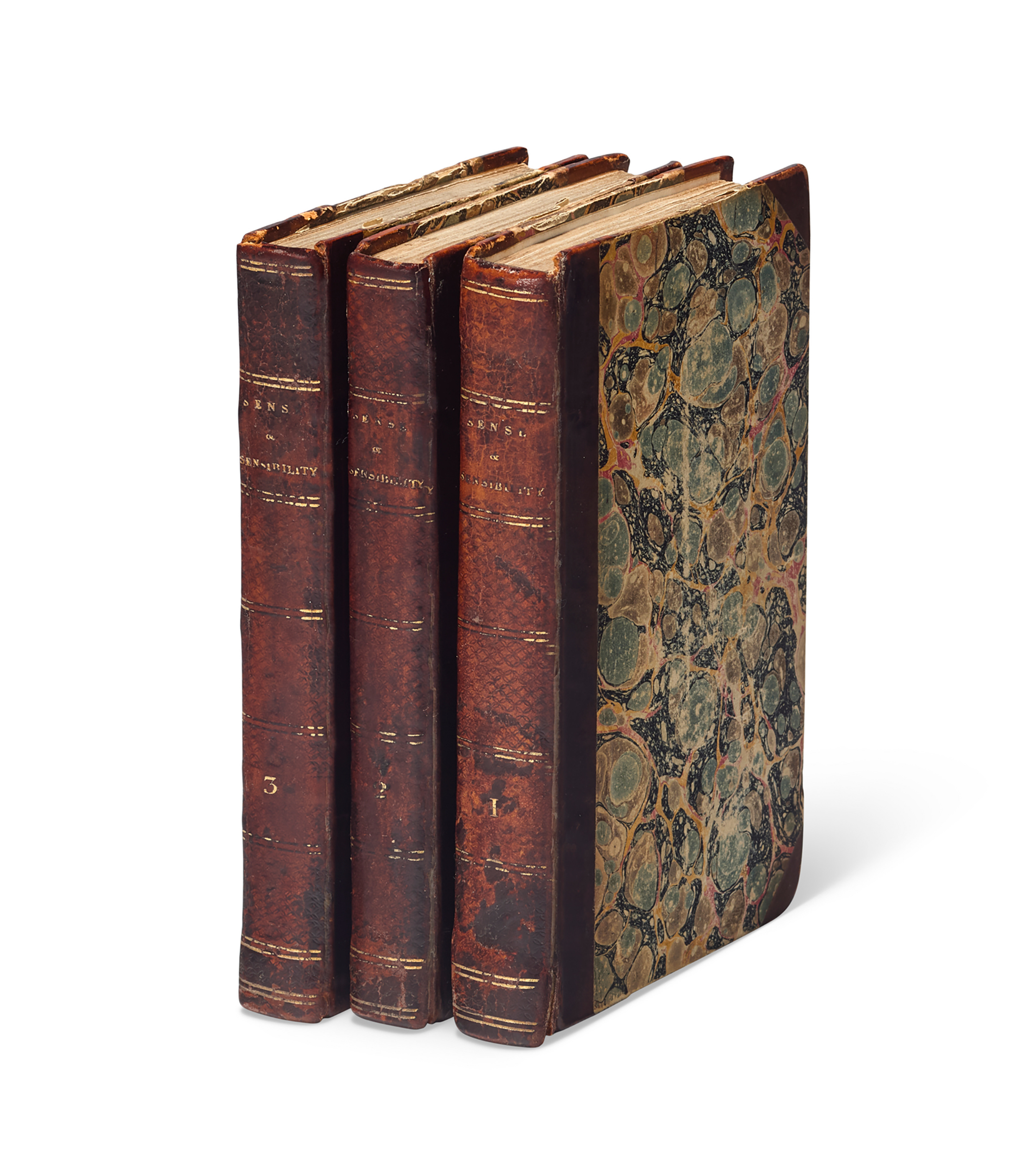 Four antique leather-bound books, including "Sense and Sensibility" by Jane Austen, standing upright.