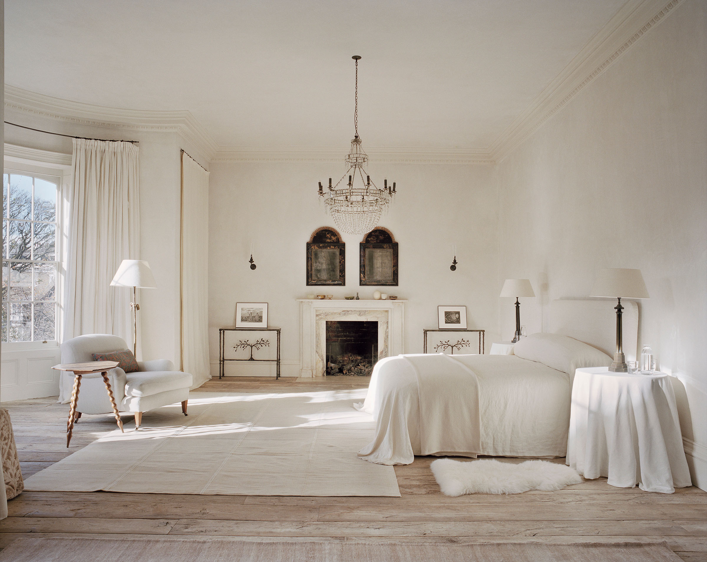 The bedroom, says Uniacke, 'is often filled with light. I stood in this space one morning, in the sunlight, and it was suddenly obvious where we should sleep, and several rooms were then combined. More symmetry here - a pair of early cushion mirrors, pair of tables - reflects the pair of us. It’s a tranquil space for sleep. Monastic, no colour, but strong, not too polite'