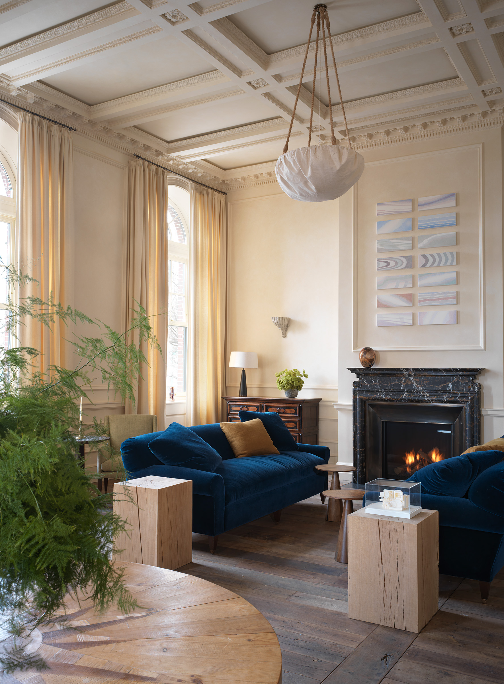 The fireplace in the drawing room of San Vicente West Village is flanked by antique Italian commodes and Rose Uniacke sofas and side tables