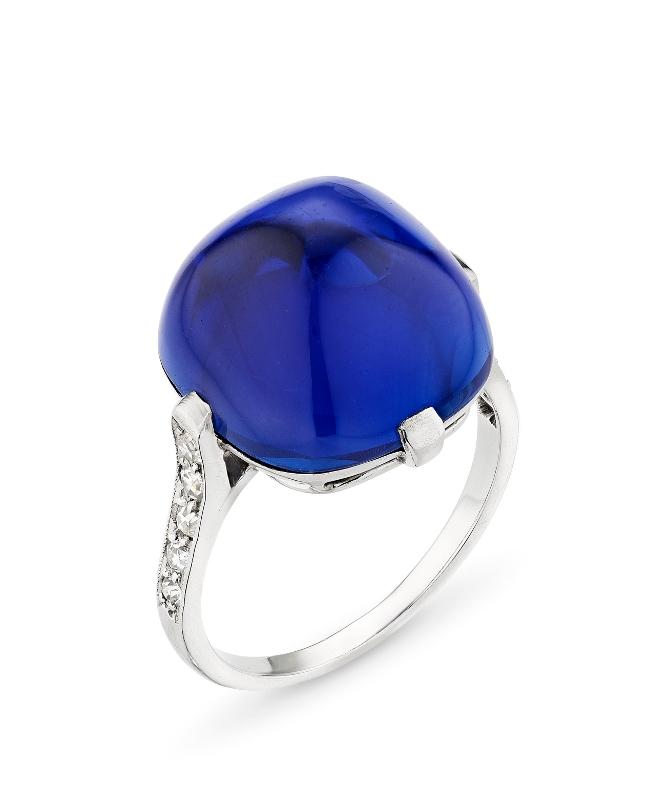 A vivid blue cabochon gemstone ring set in silver with small diamonds on the band.