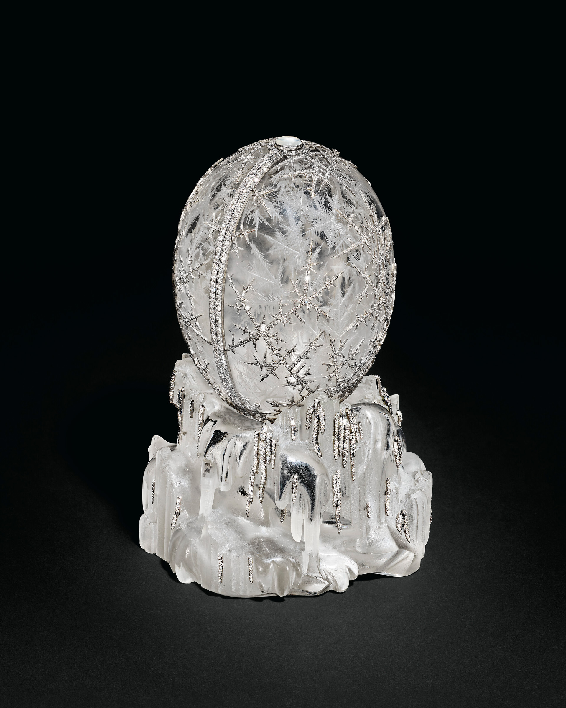 The rock-crystal egg, on a base of the same material formed as a block of melting ice, is engraved on the interior with a frost design, while the exterior is decorated with platinum snowflake motifs set with rose-cut diamonds. Offered in The Winter Egg and Important Works by Faberge from a Princely Collection on 2 December 2025 at Christie's in London